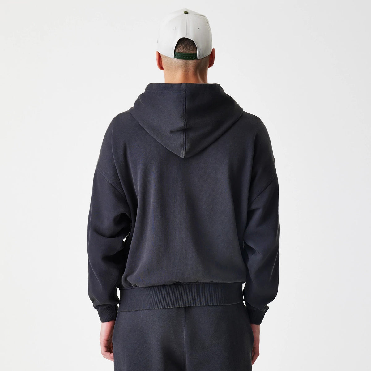 The Male model is wearing  New Era Washed Black Oversized Full Zip Hoodie 2