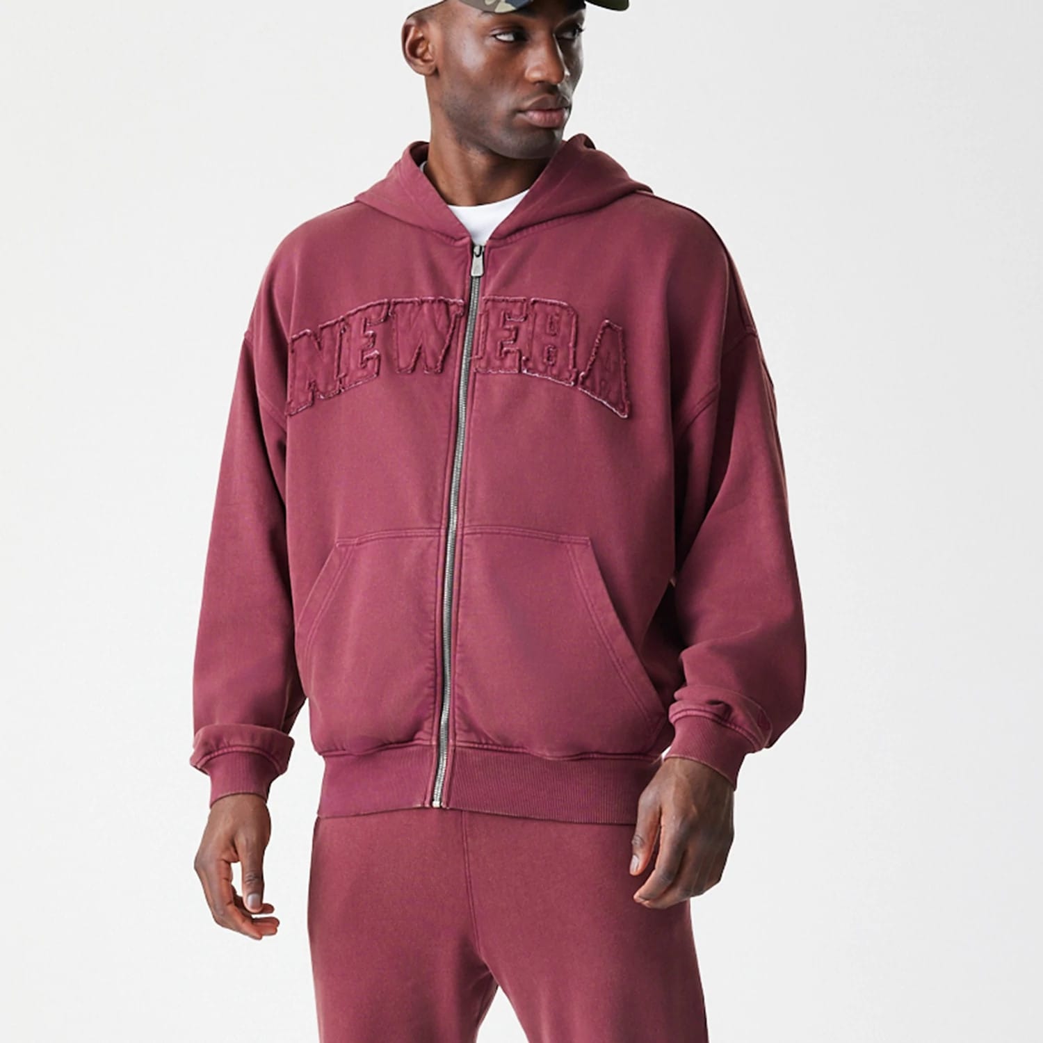 The Male model is wearing  New Era Washed Dark Red Oversized Full Zip Hoodie 8