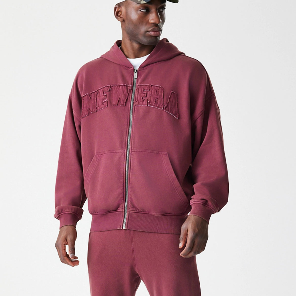 The Male model is wearing  New Era Washed Dark Red Oversized Full Zip Hoodie 8