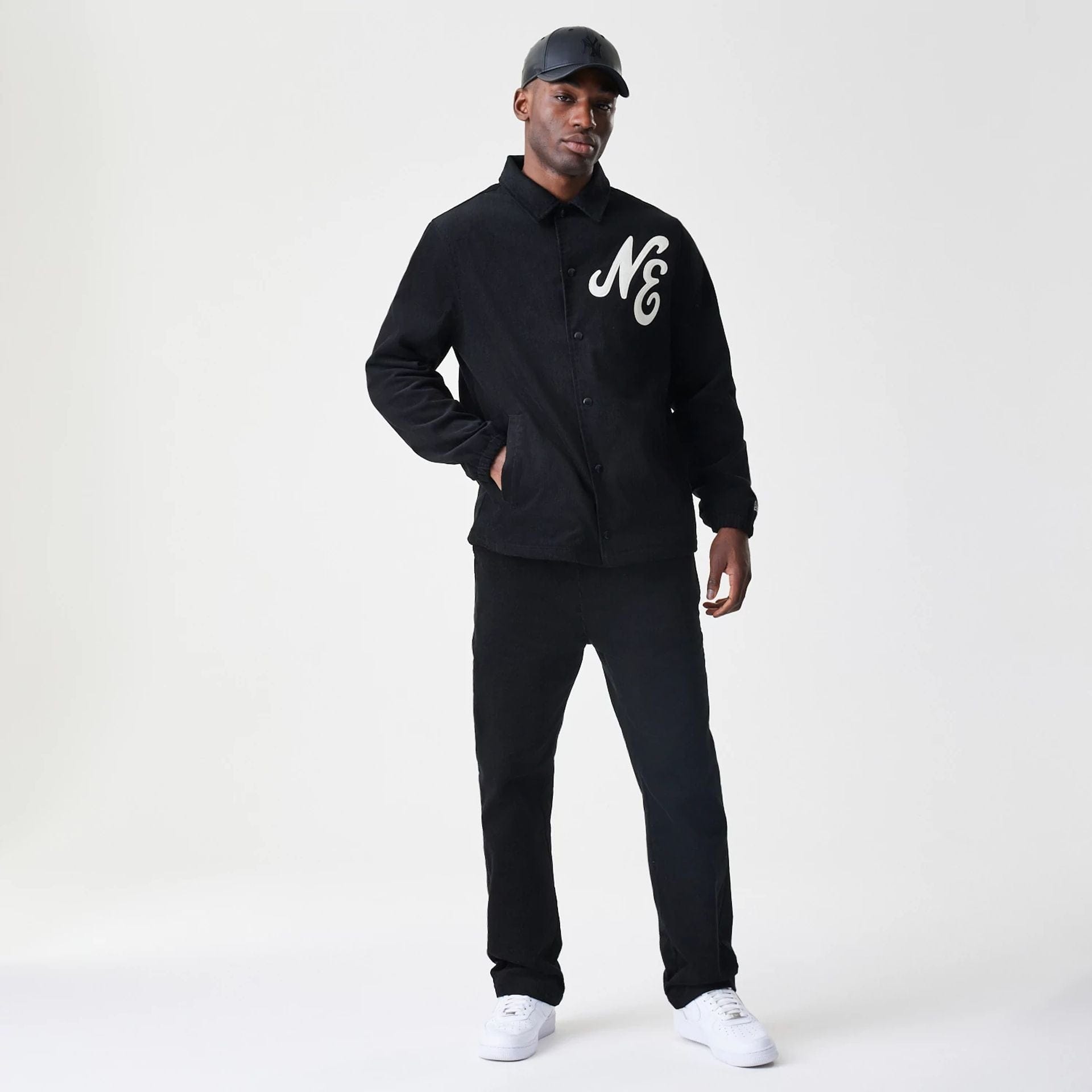 The Male model is wearing  New Era Cord Black Straight Leg Chinos 8