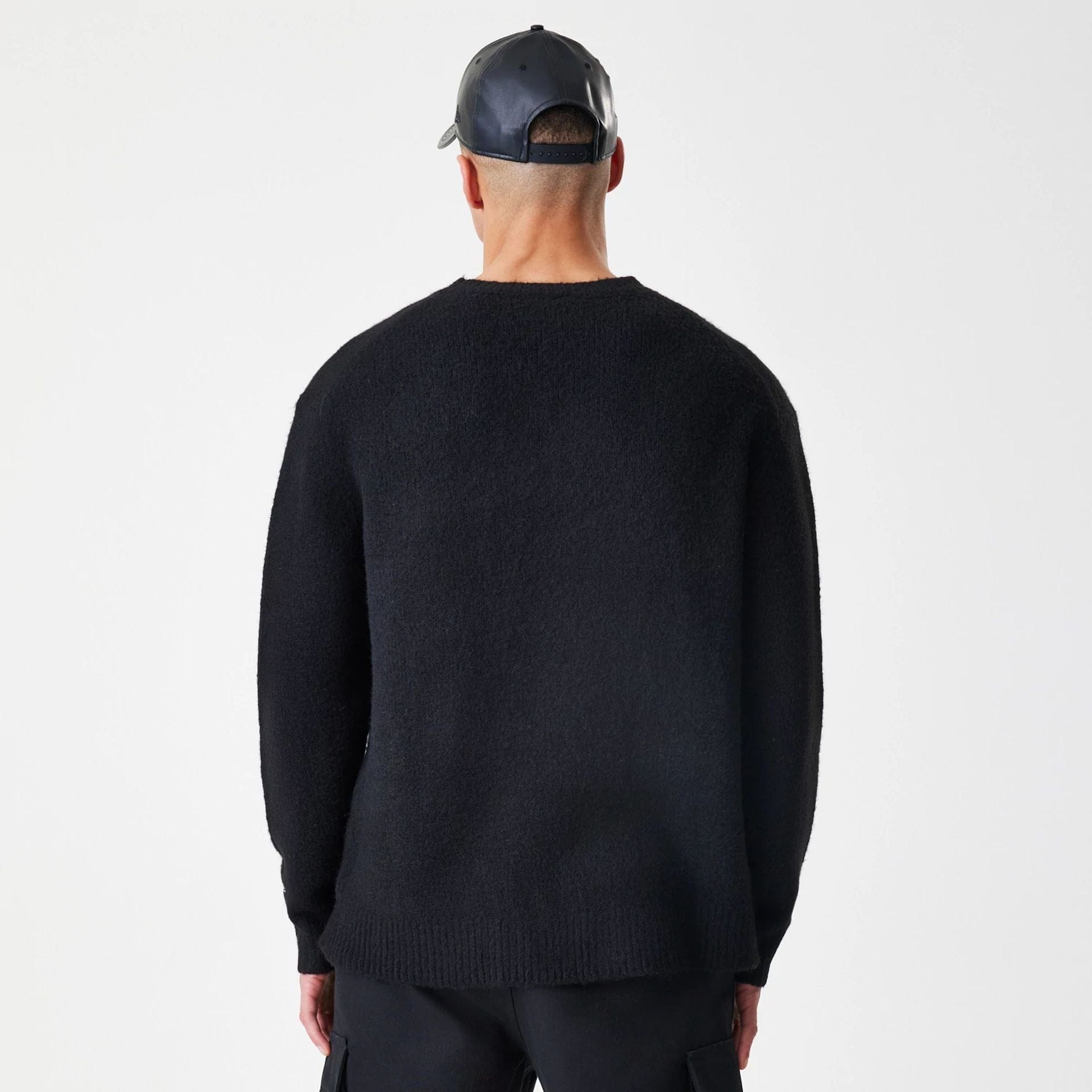 The Male model is wearing New Era Knit Black Knitted Sweater 2