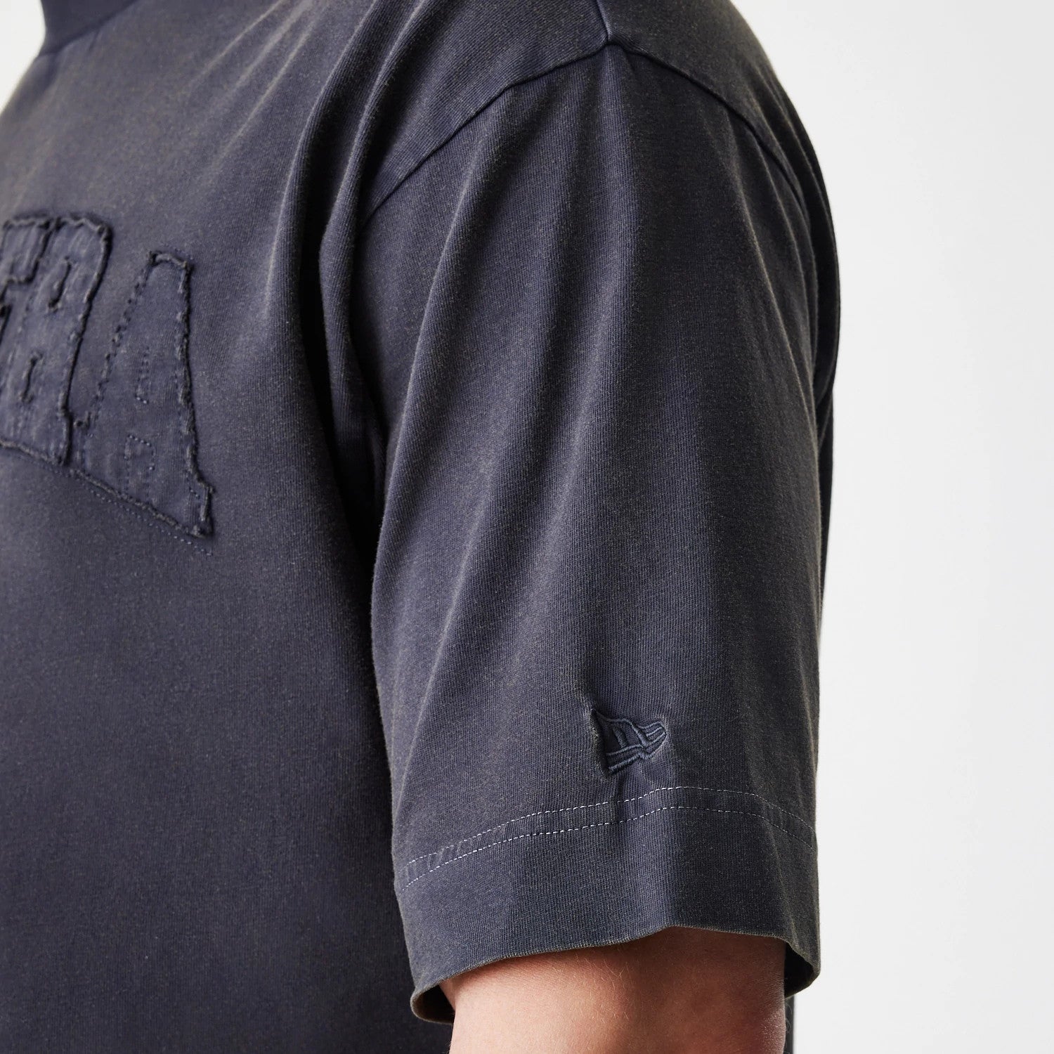 The Male model is wearing  New Era Washed Black Oversized T-Shirt 7
