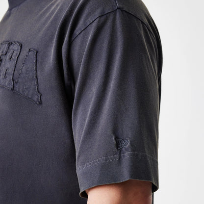The Male model is wearing  New Era Washed Black Oversized T-Shirt 7