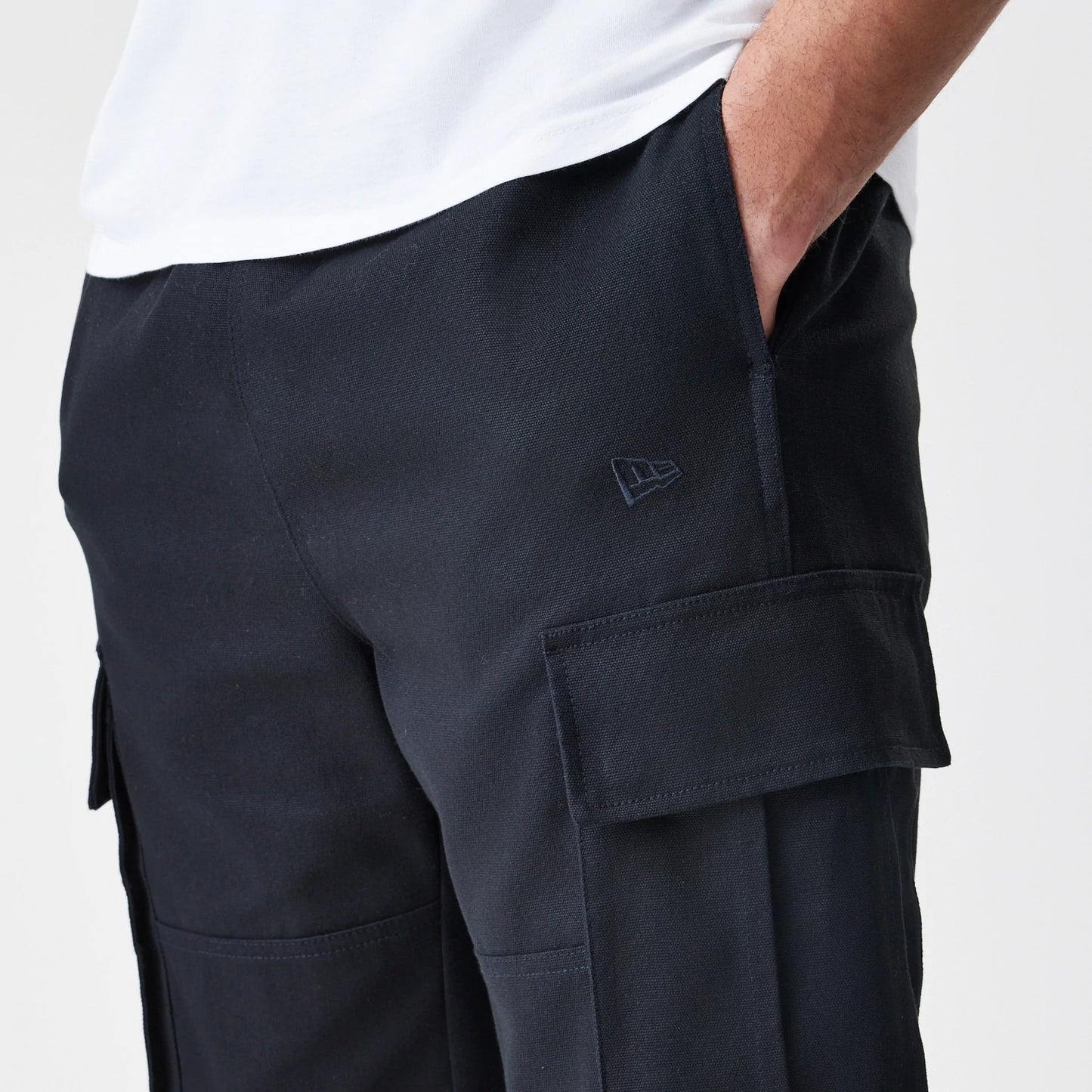 The Male model is wearing  New Era Cargo Black Straight Leg Trousers 5