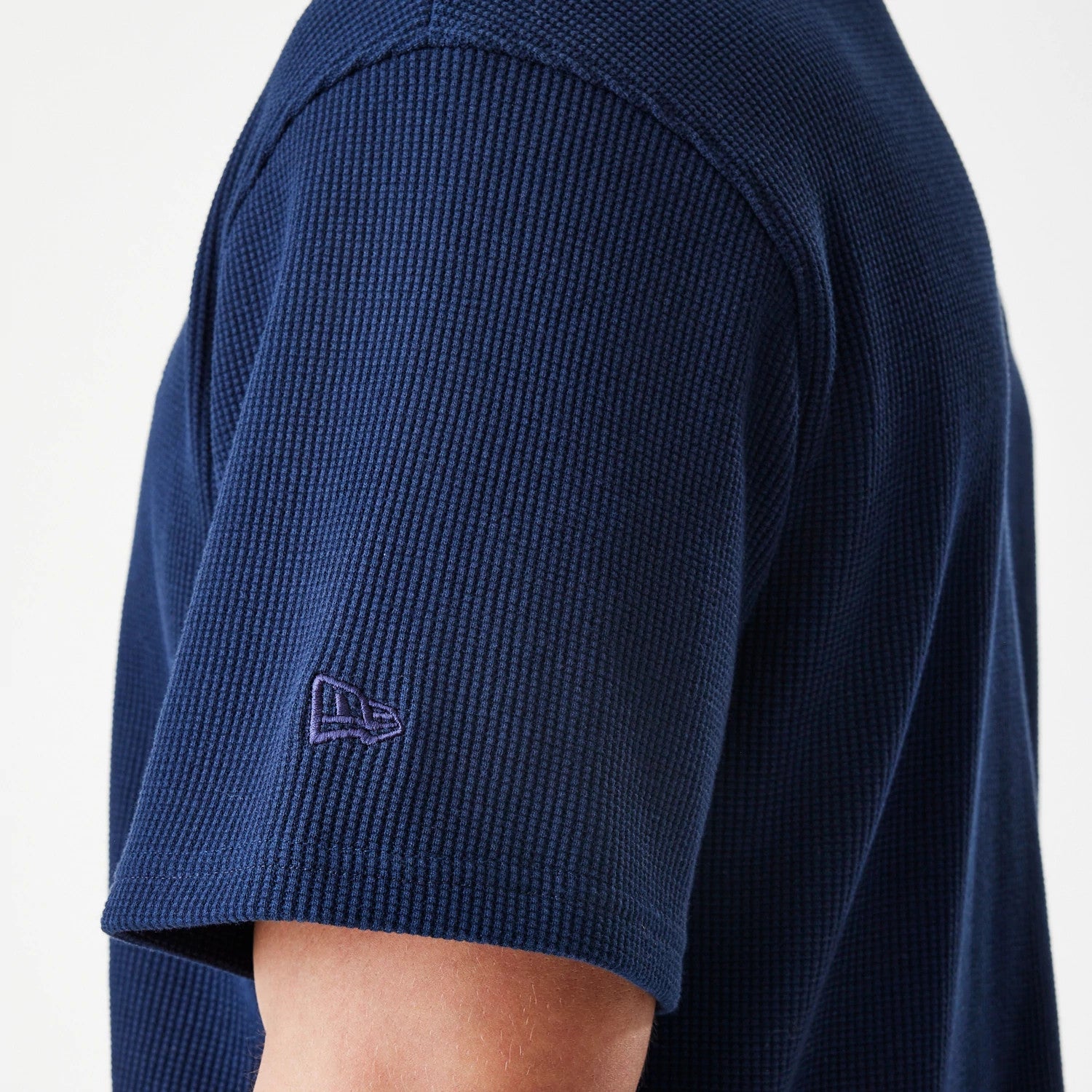 The Male model is wearing  New Era Waffle Navy Jersey 7