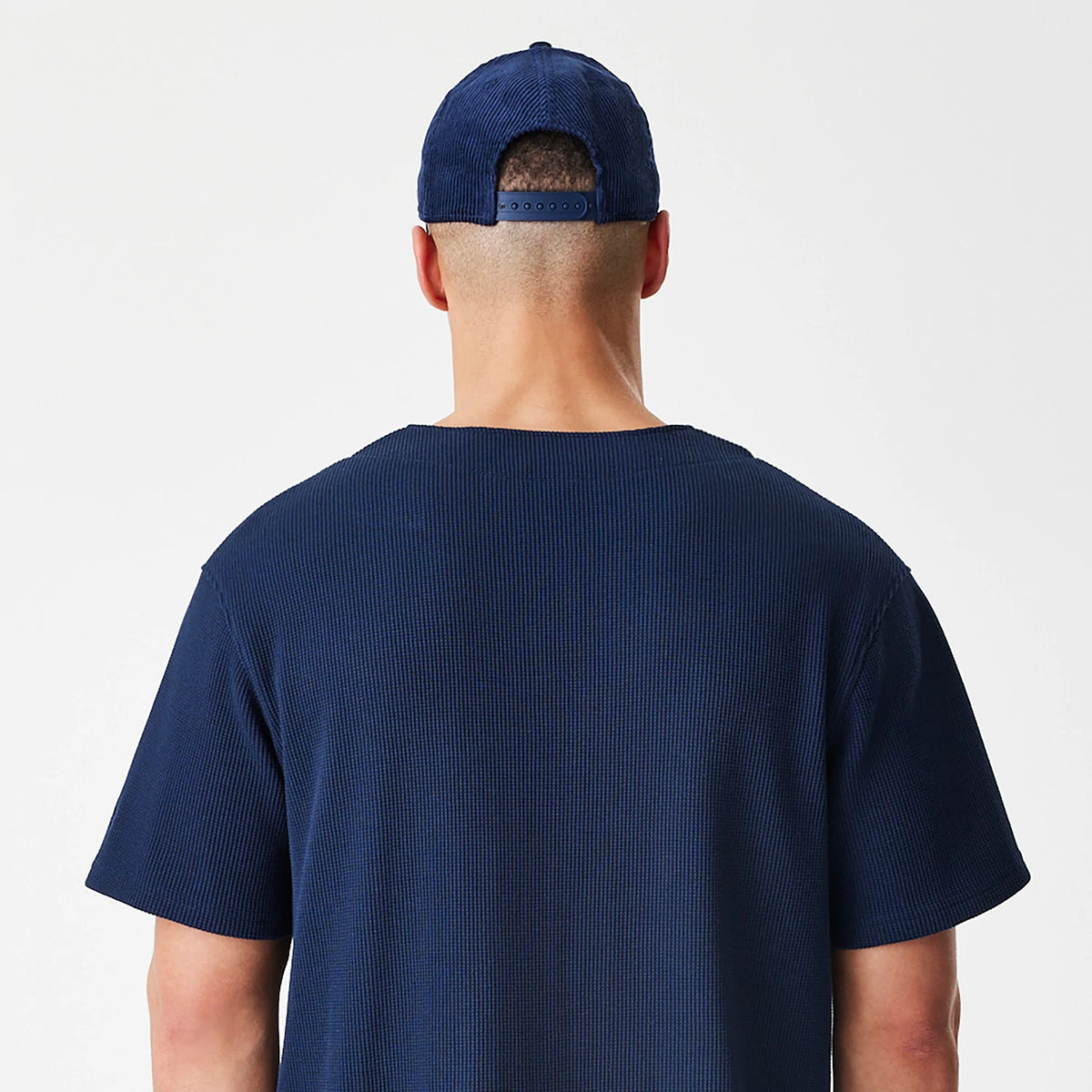 The Male model is wearing  New Era Waffle Navy Jersey 8