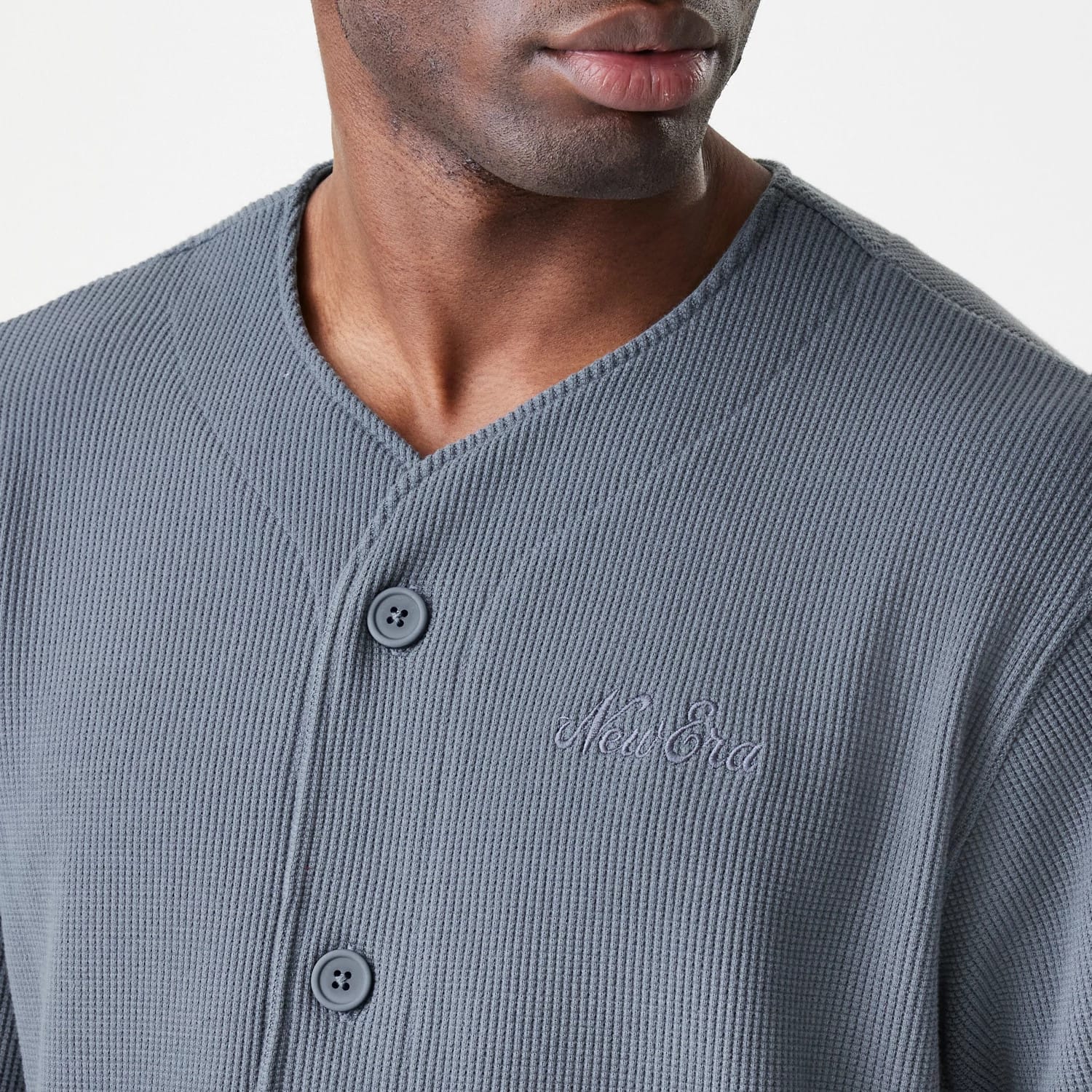 The Male model is wearing  New Era Waffle Dark Grey Jersey 6