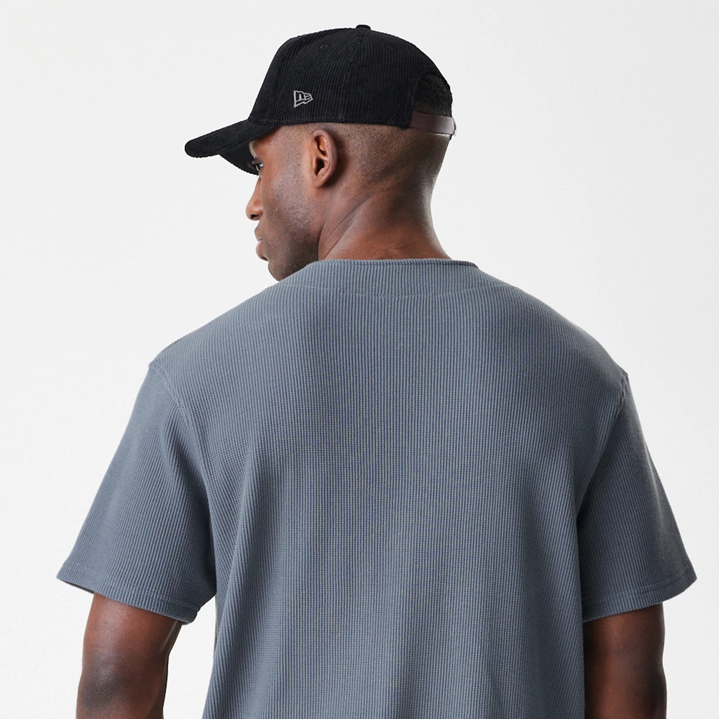 The Male model is wearing  New Era Waffle Dark Grey Jersey 5