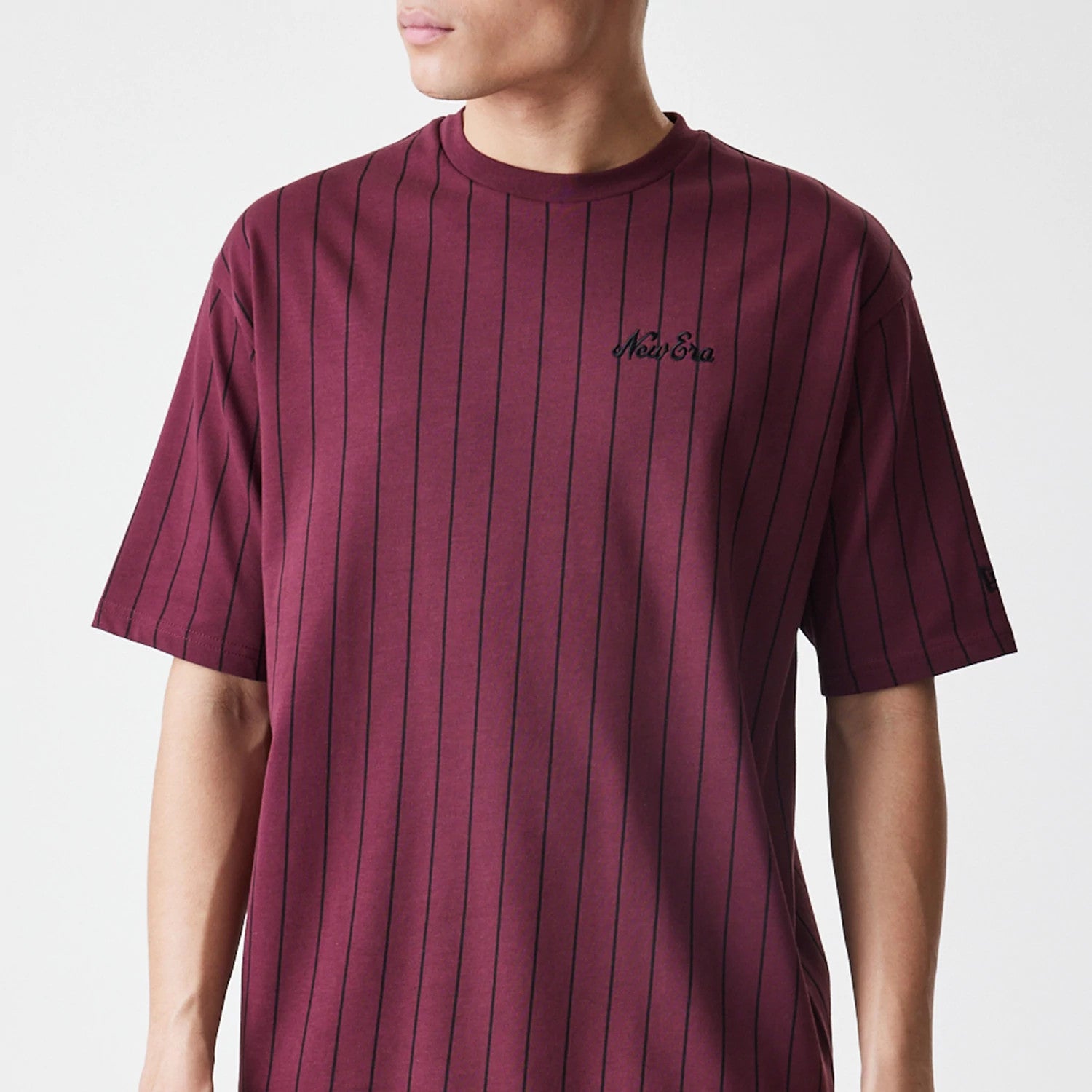 The Male model is wearing  New Era Pinstripe Dark Red Oversized T-Shirt 3