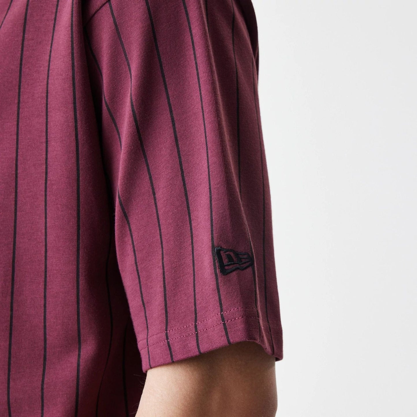 The Male model is wearing  New Era Pinstripe Dark Red Oversized T-Shirt  5