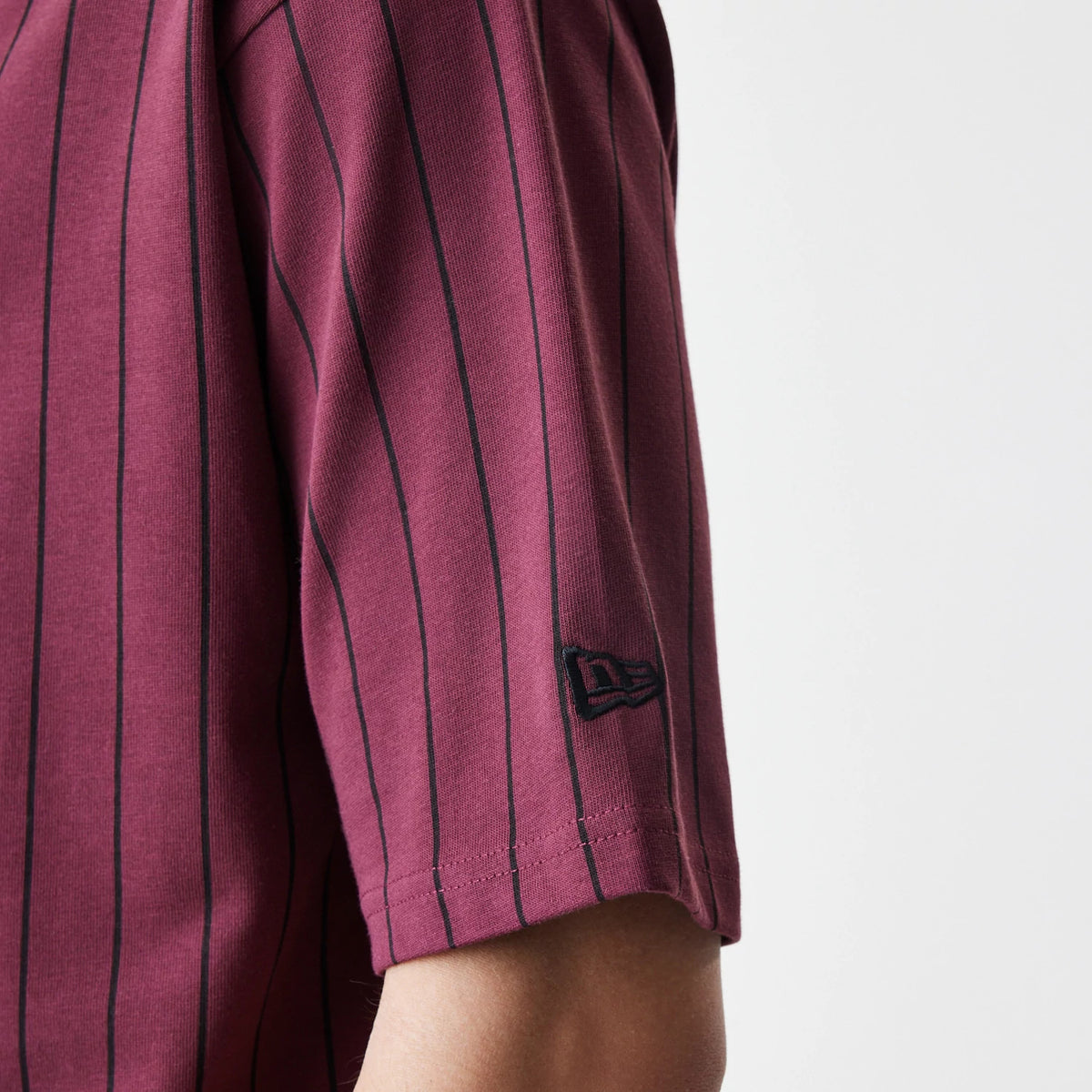 The Male model is wearing  New Era Pinstripe Dark Red Oversized T-Shirt 5