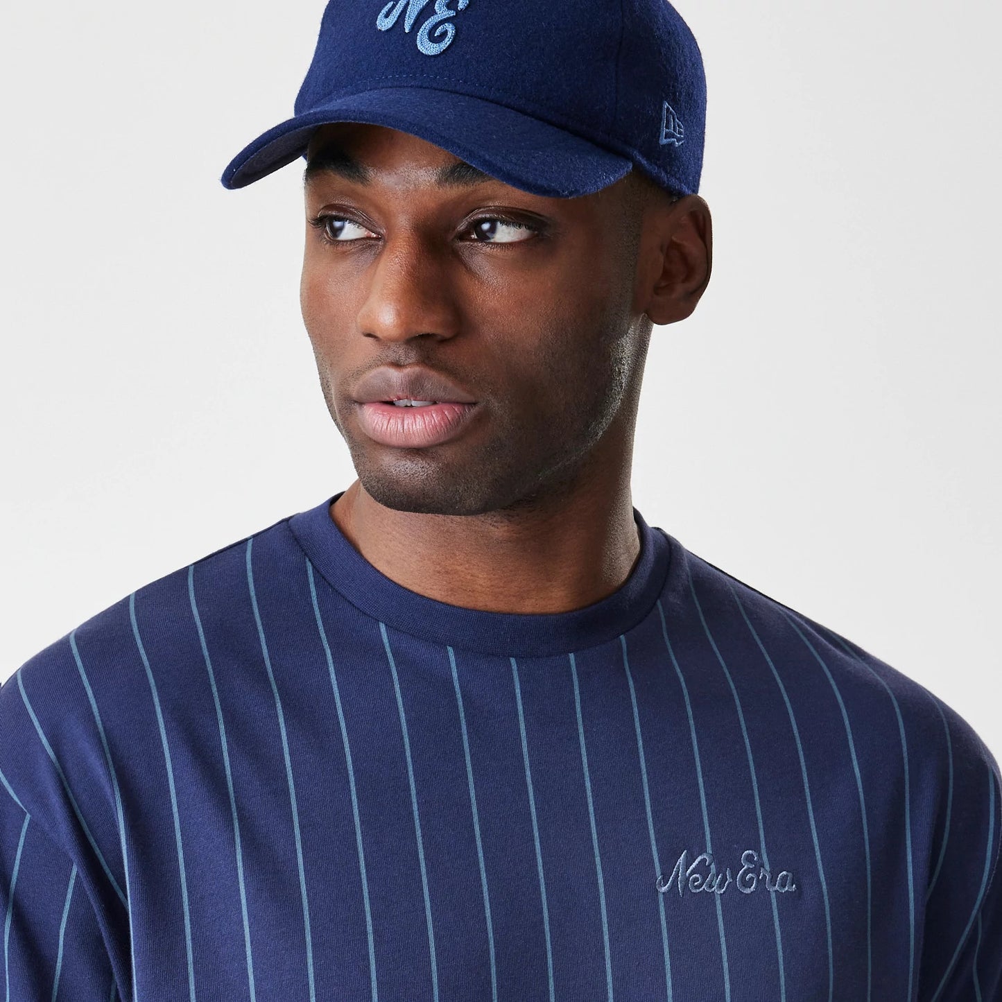 The Male model is wearing  New Era Pinstripe Navy Oversized T-Shirt 4