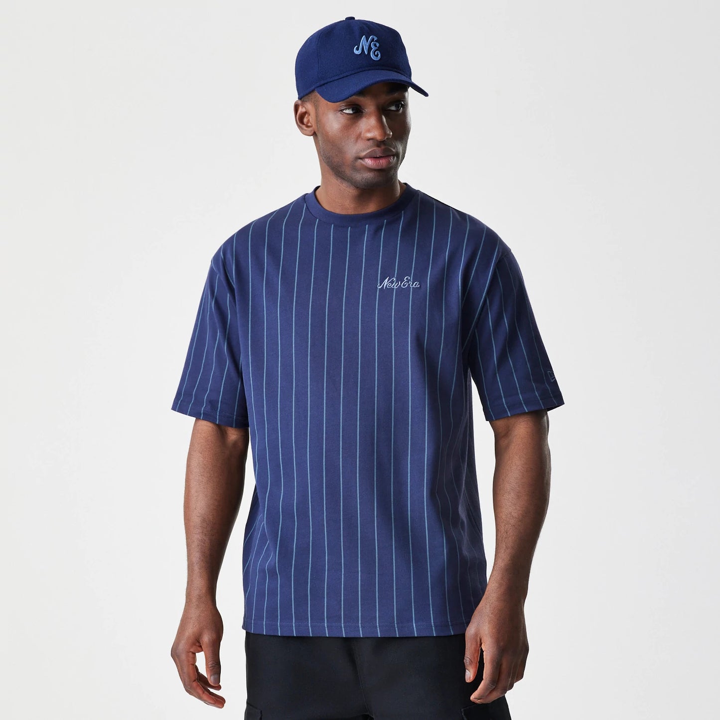 The Male model is wearing  New Era Pinstripe Navy Oversized T-Shirt 1
