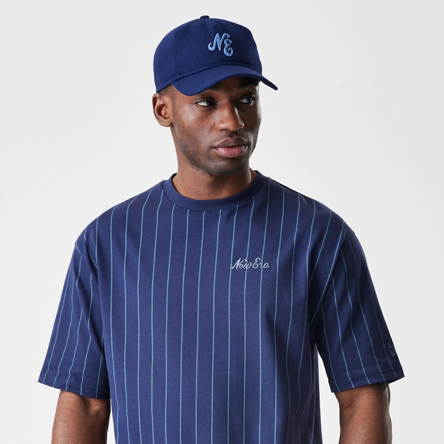 The Male model is wearing  New Era Pinstripe Navy Oversized T-Shirt 6