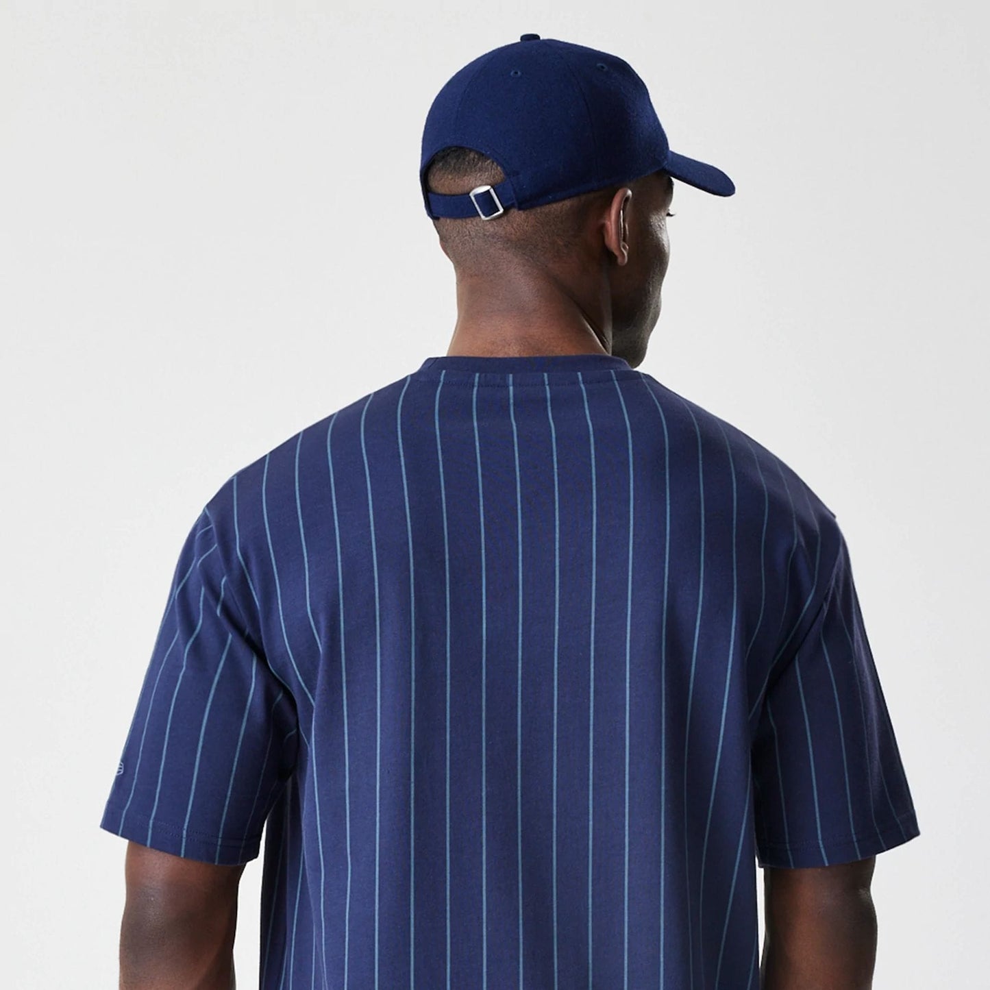 The Male model is wearing  New Era Pinstripe Navy Oversized T-Shirt  7