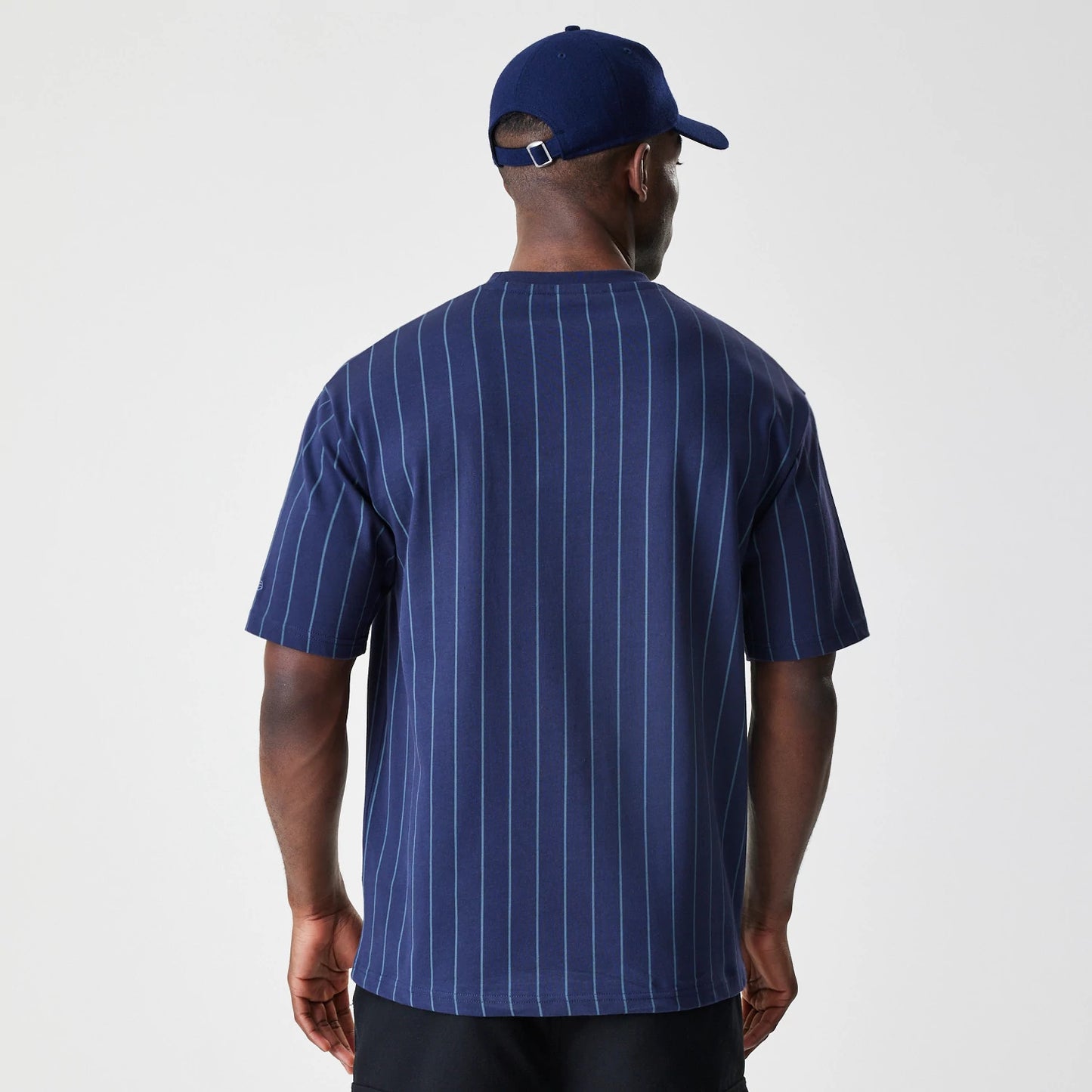 The Male model is wearing  New Era Pinstripe Navy Oversized T-Shirt 2
