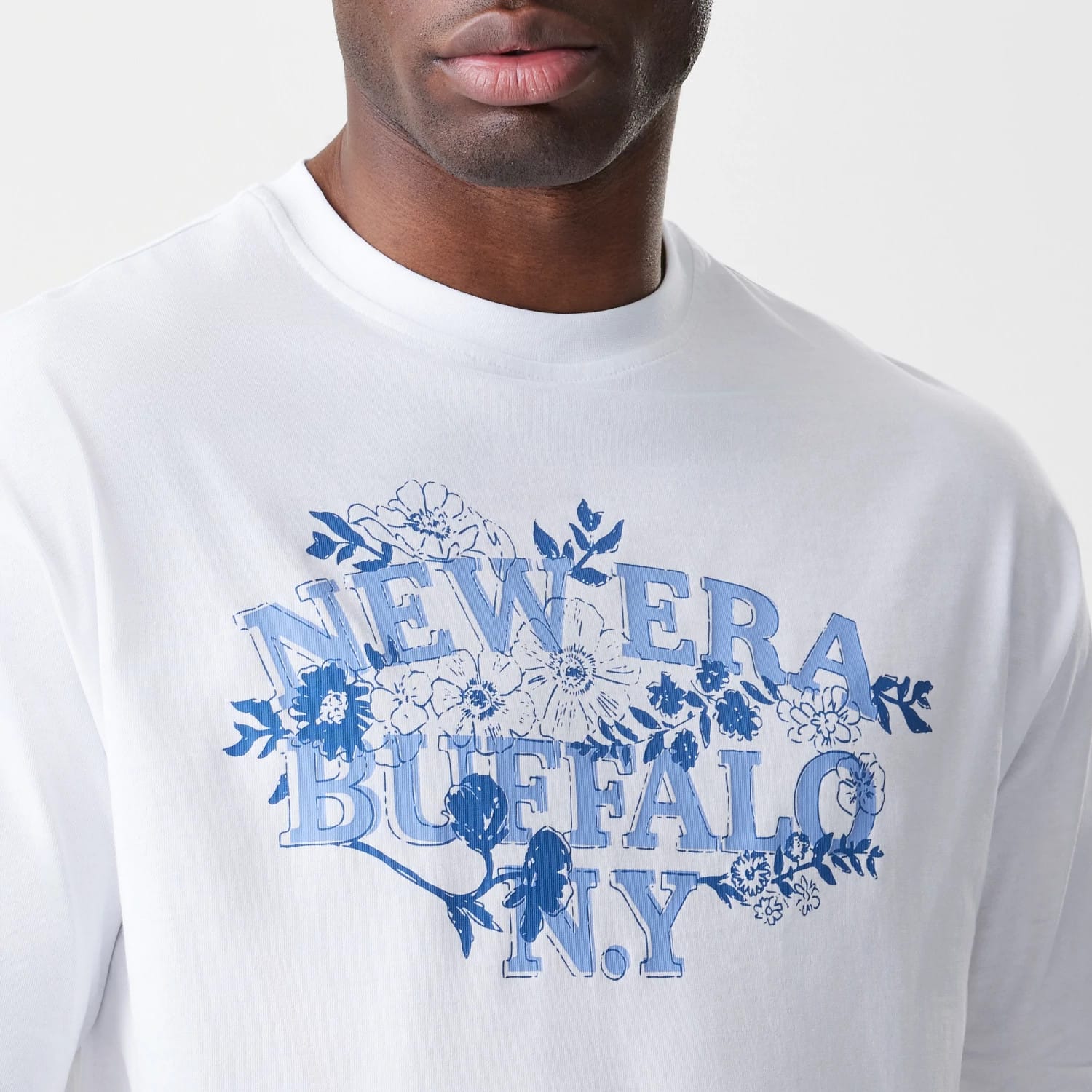 The Male model is wearing  New Era Floral White Oversized T-Shirt 5