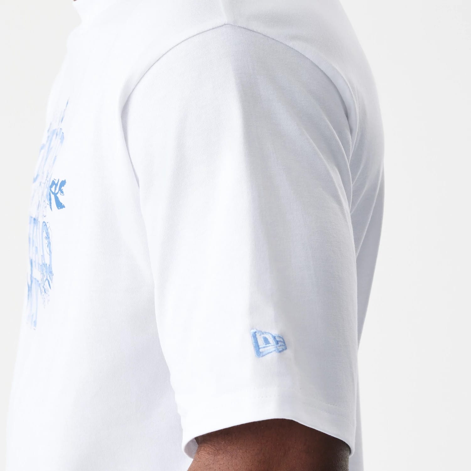 The Male model is wearing  New Era Floral White Oversized T-Shirt 7