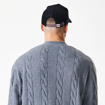 New Era New York Yankees MLB Cable Knit Dark Grey Cardigan, rear view on a model showing the intricate cable knit pattern on the back, highlighting the textured design and rich dark grey colour.