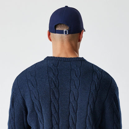 New Era New York Yankees MLB Cable Knit Navy Knitted Sweater, rear view on a model with a plain navy cap, showcasing the intricate cable knit pattern on the back and ribbed neckline of the sweater.