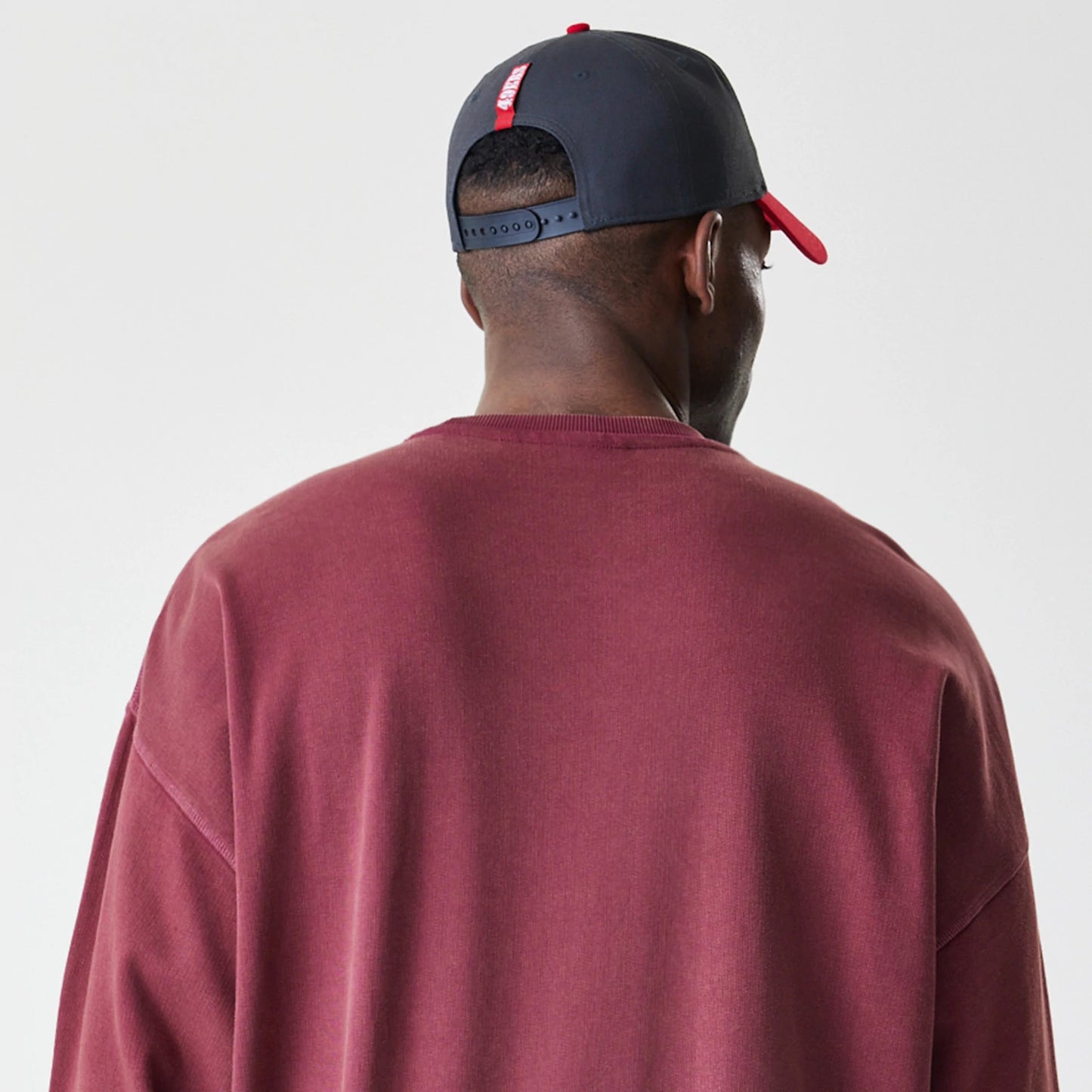 The Male model is wearing San Francisco 49ers NFL Washed Boxy Dark Red Oversized Crew Neck Sweater 7