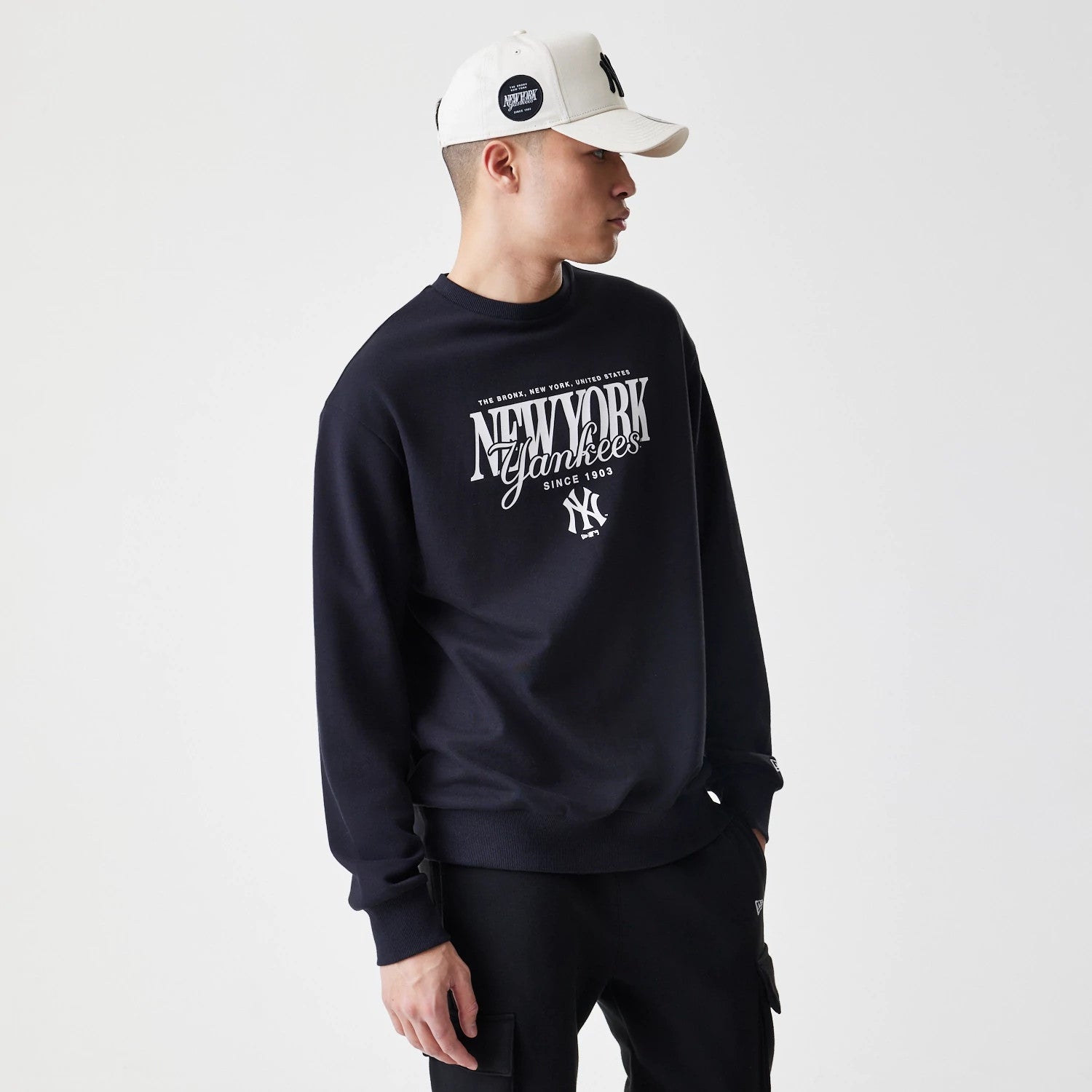 The Male model is wearing New York Yankees MLB Script Black Crew Neck Sweater 1