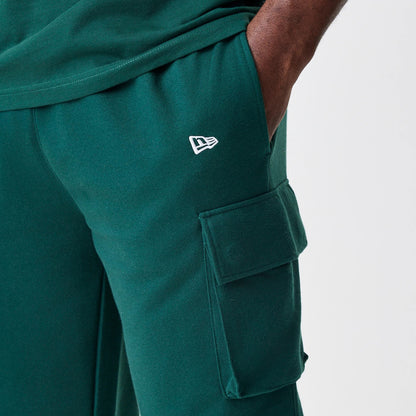 The Male model is wearing  New Era Core Cargo Dark Green Joggers 7