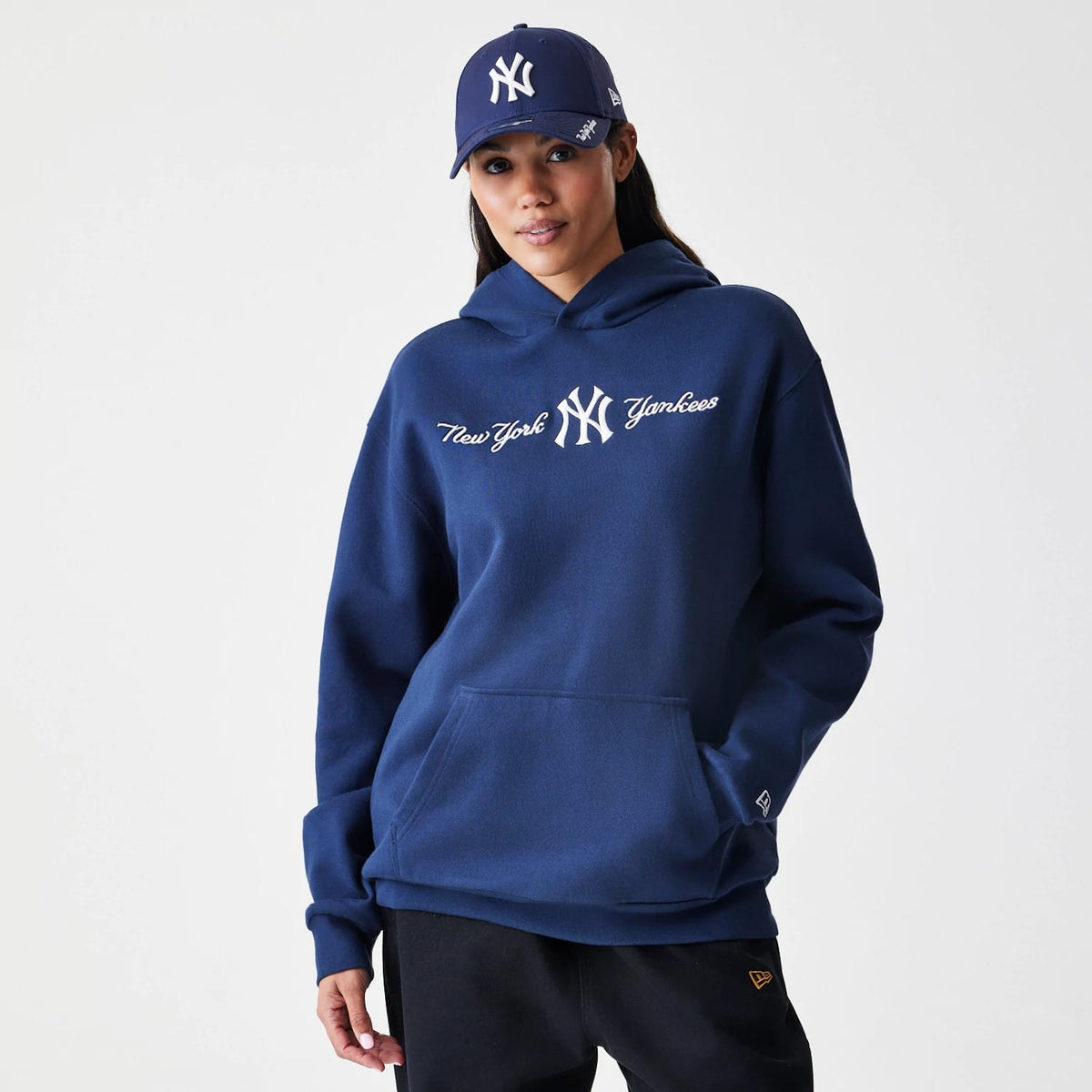 The Male model is wearing New York Yankees MLB Script Navy Oversized Pullover Hoodie 4