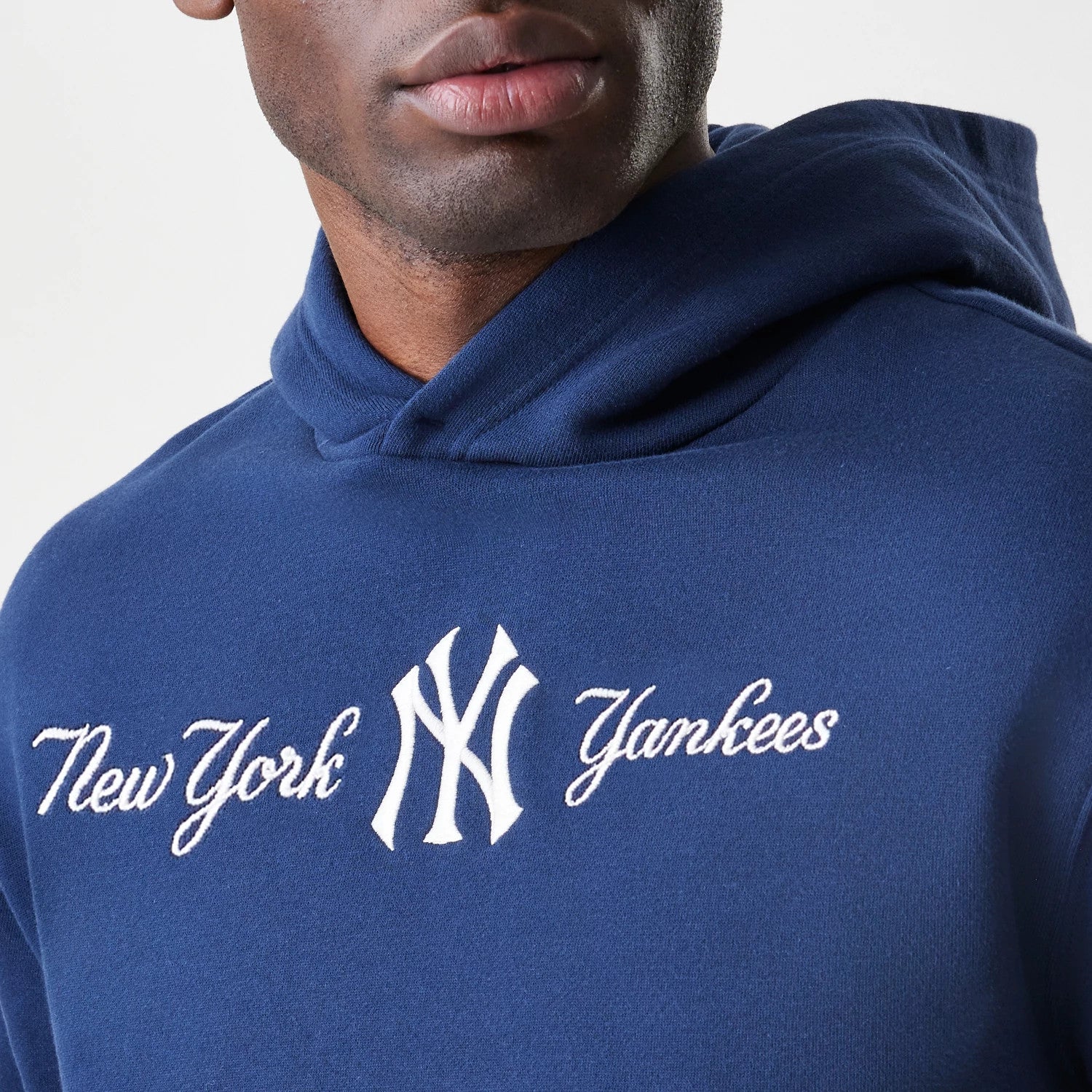 The Male model is wearing New York Yankees MLB Script Navy Oversized Pullover Hoodie 6