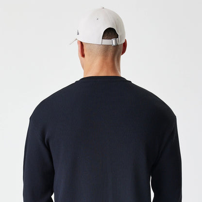 The Male model is wearing  New Era Waffle Black Long Sleeve T-Shirt 7
