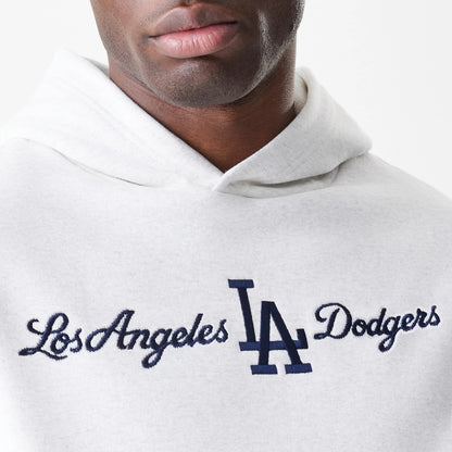 New Era LA Dodgers MLB Script White Oversized Pullover Hoodie, front view with navy embroidered Los Angeles Dodgers script across the chest, worn by a model showcasing the hood and shoulder design.