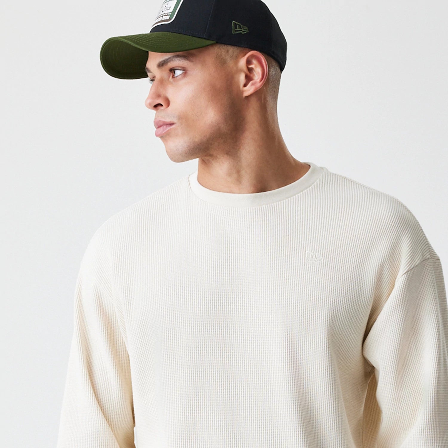 The Male model is wearing  New Era Waffle Light Beige Long Sleeve T-Shirt 4