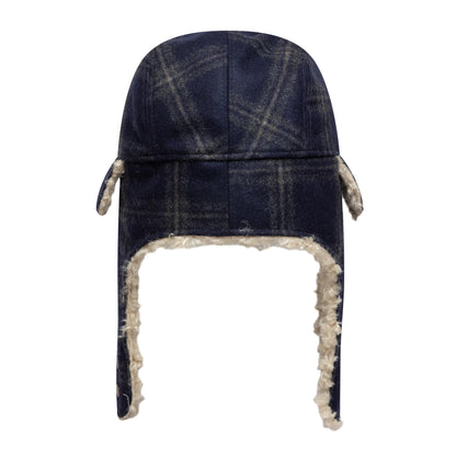 New Era Loden Navy Trapper Hat, front view showing the navy and grey check pattern on a structured crown with plush cream faux fur lining the edge and ear flaps, giving a warm winter look.