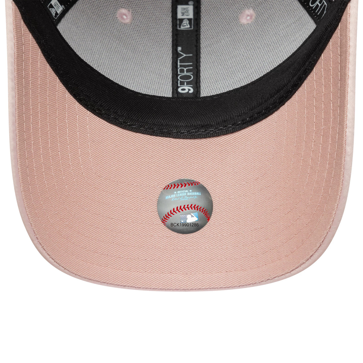New York Yankees Womens MLB Satin Bow Back Pastel Pink New Era 9FORTY Adjustable Cap, inside view showing the black taped seams, fabric sweatband, pink undervisor and baseball hologram sticker beneath the curved visor.