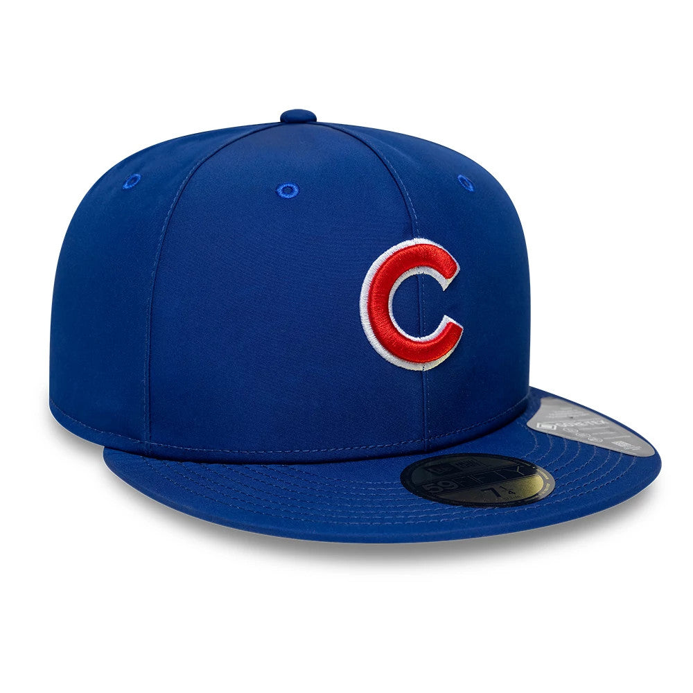 Chicago Cubs MLB Gore-Tex Blue New Era 59FIFTY Fitted Cap, three-quarter view showing the red and white embroidered Cubs logo on the front panel, blue flat visor with a gold 59FIFTY size sticker, and matching blue top button and eyelets.
