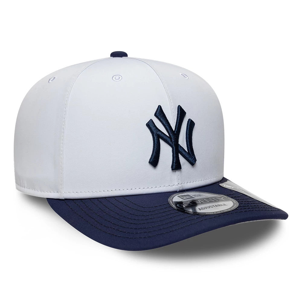 New York Yankees MLB Gore-Tex White New Era 9SEVENTY Stretch Snap Adjustable Cap, three-quarter view showing the raised navy NY logo on the front panel, with a contrasting navy visor featuring a 9SEVENTY size sticker.