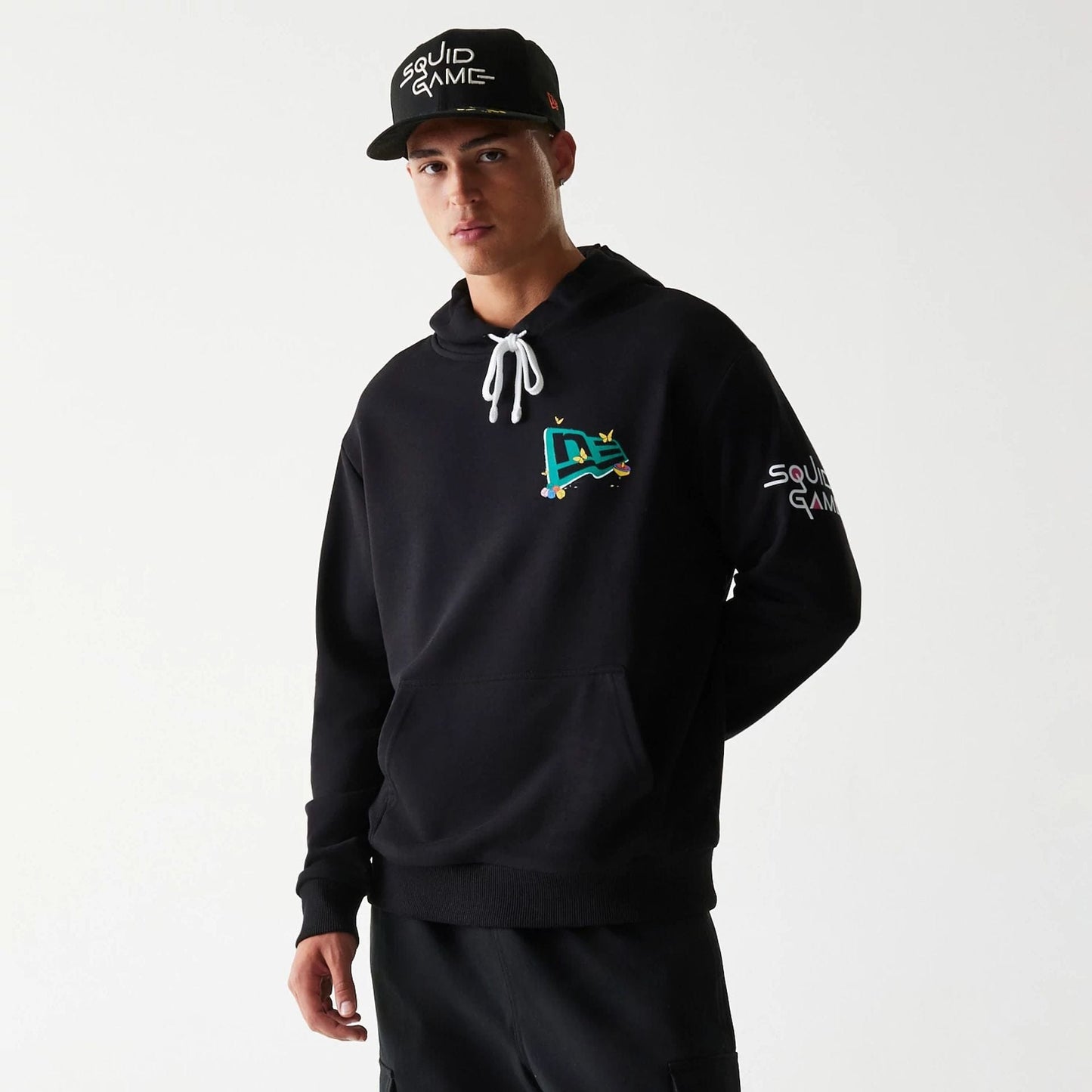 The Male model is wearing Netflix Squid Game Black Oversized Pullover Hoodie 1