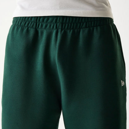 The Male model is wearing New Era Front Logo Dark Green Shorts 5