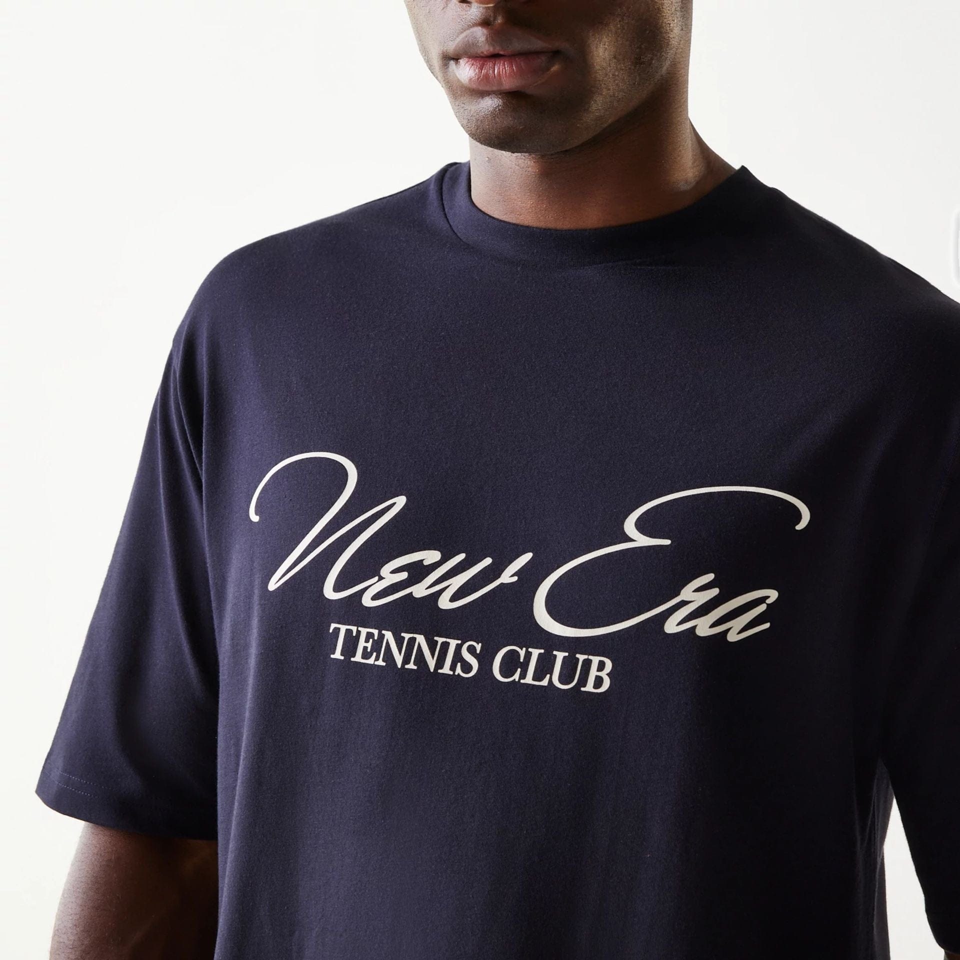 The Male model is wearing New Era Navy Oversized T-Shirt 4