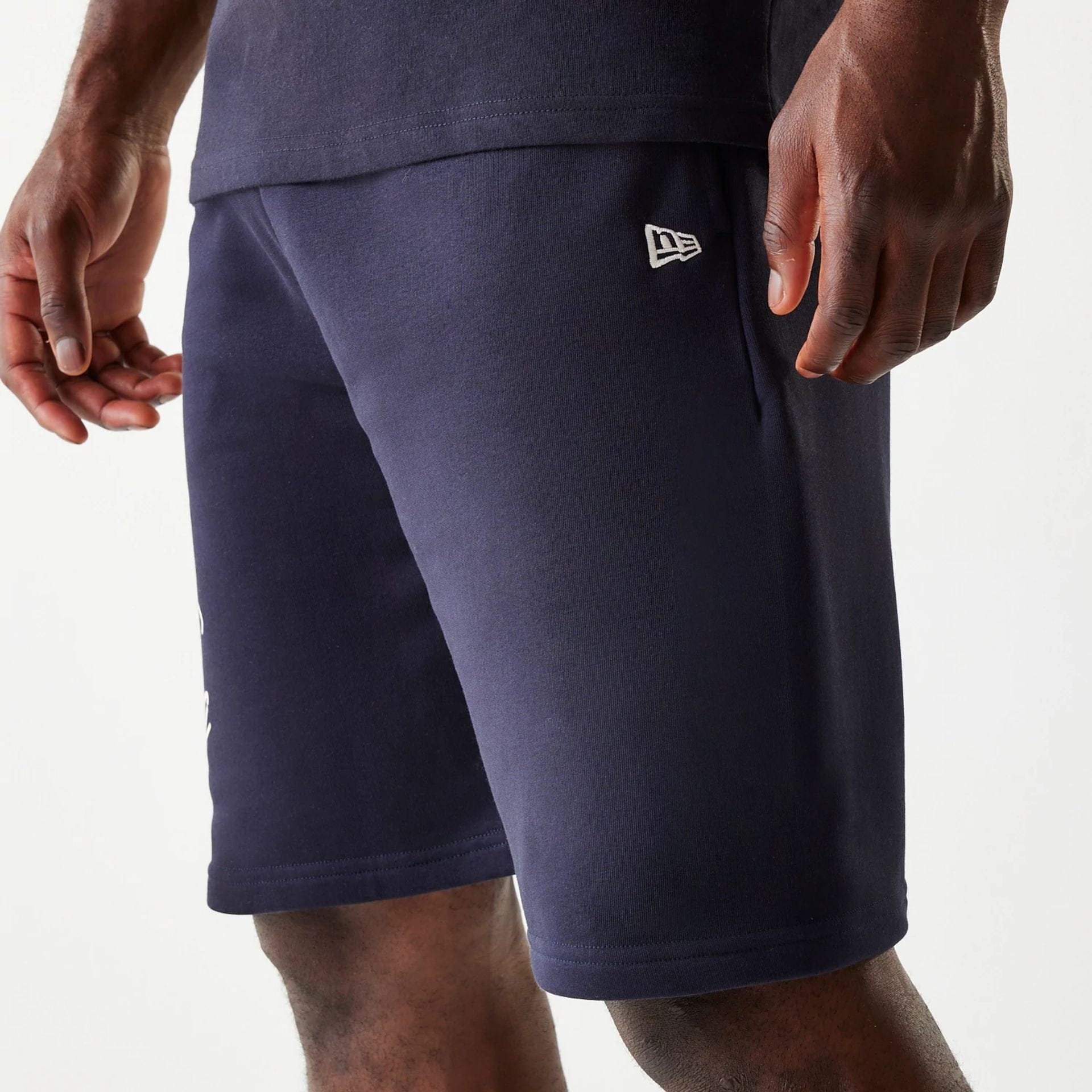 The Male model is wearing New Era Side Logo Navy Shorts 6