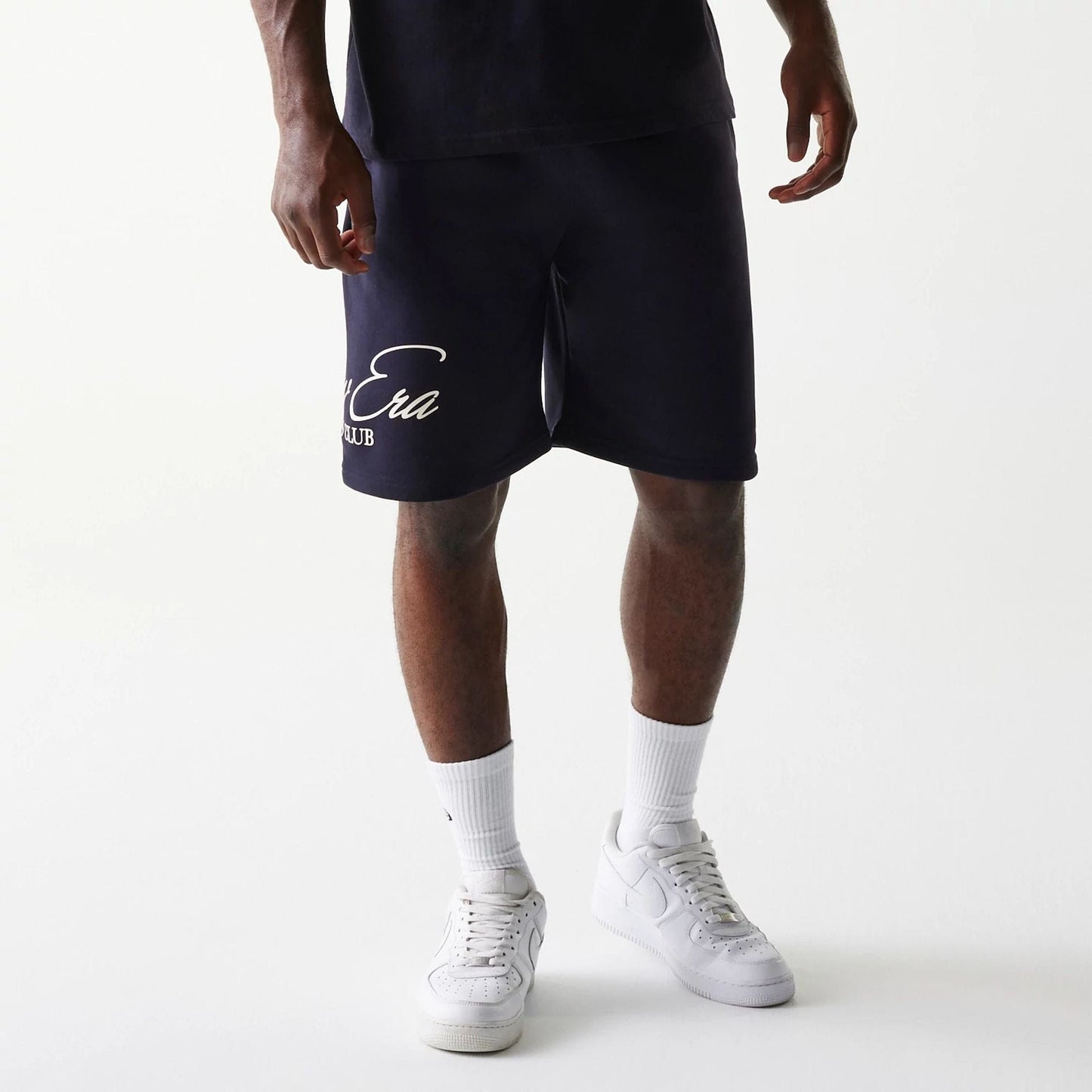 The Male model is wearing New Era Side Logo Navy Shorts 1
