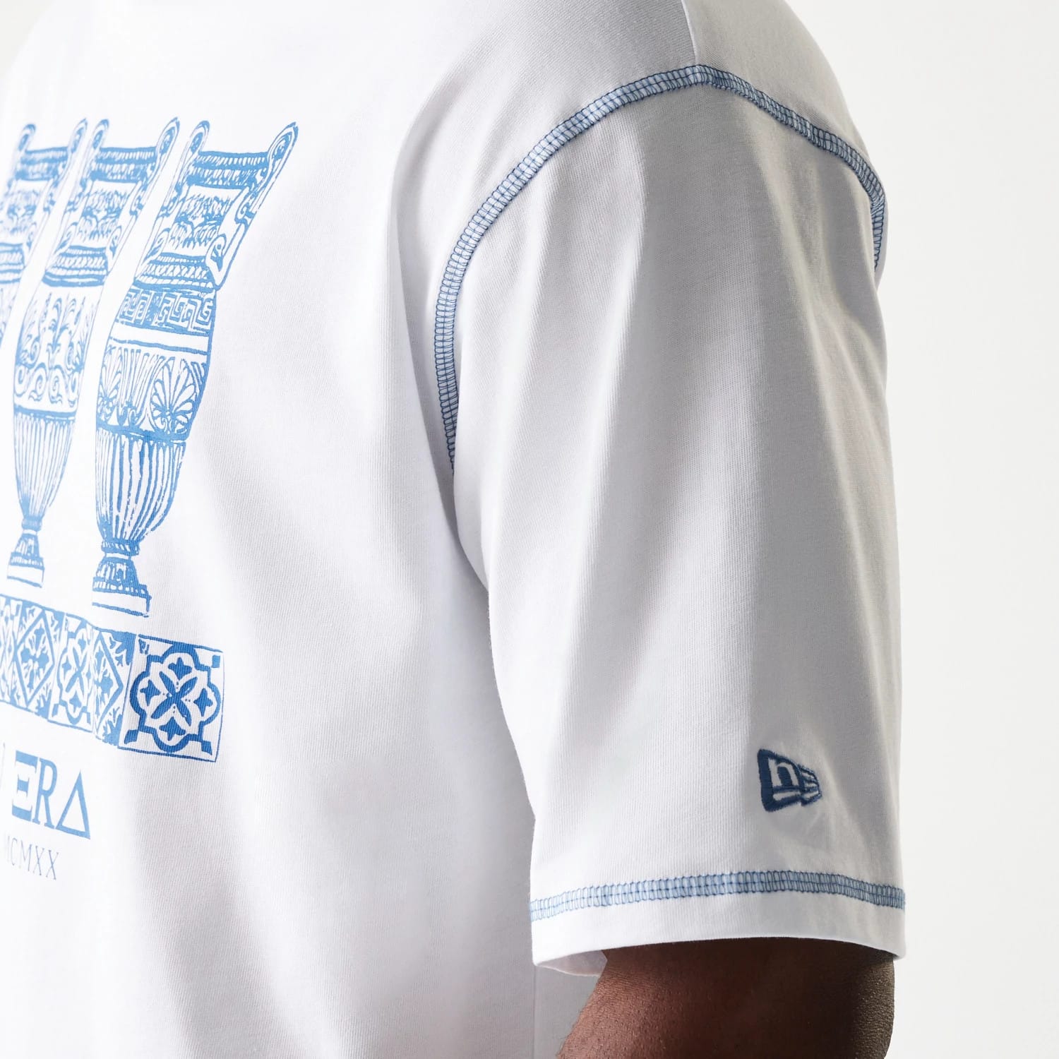 The Male model is wearing New Era Orthodox Vase White Oversized T-Shirt 5