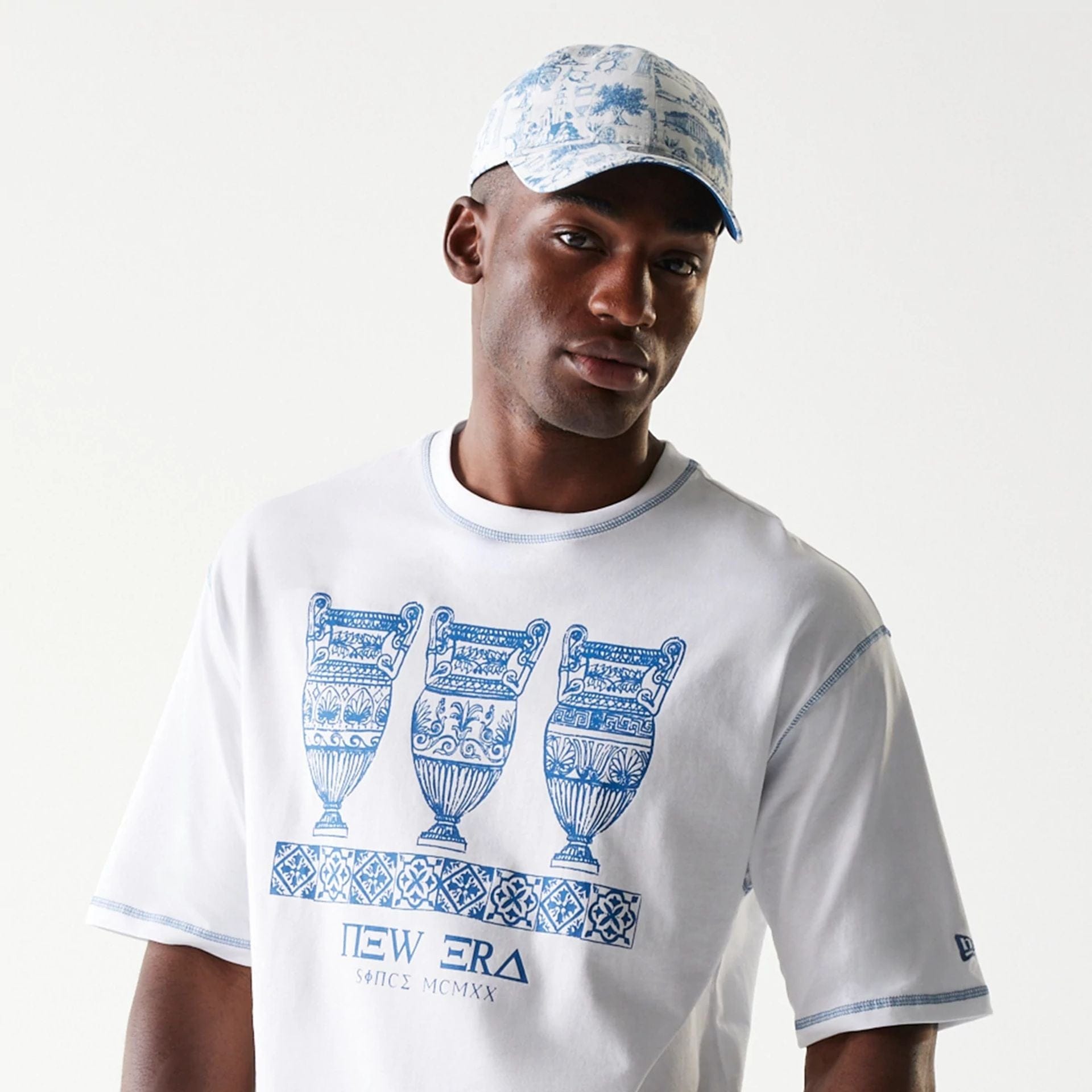 The Male model is wearing New Era Orthodox Vase White Oversized T-Shirt 6