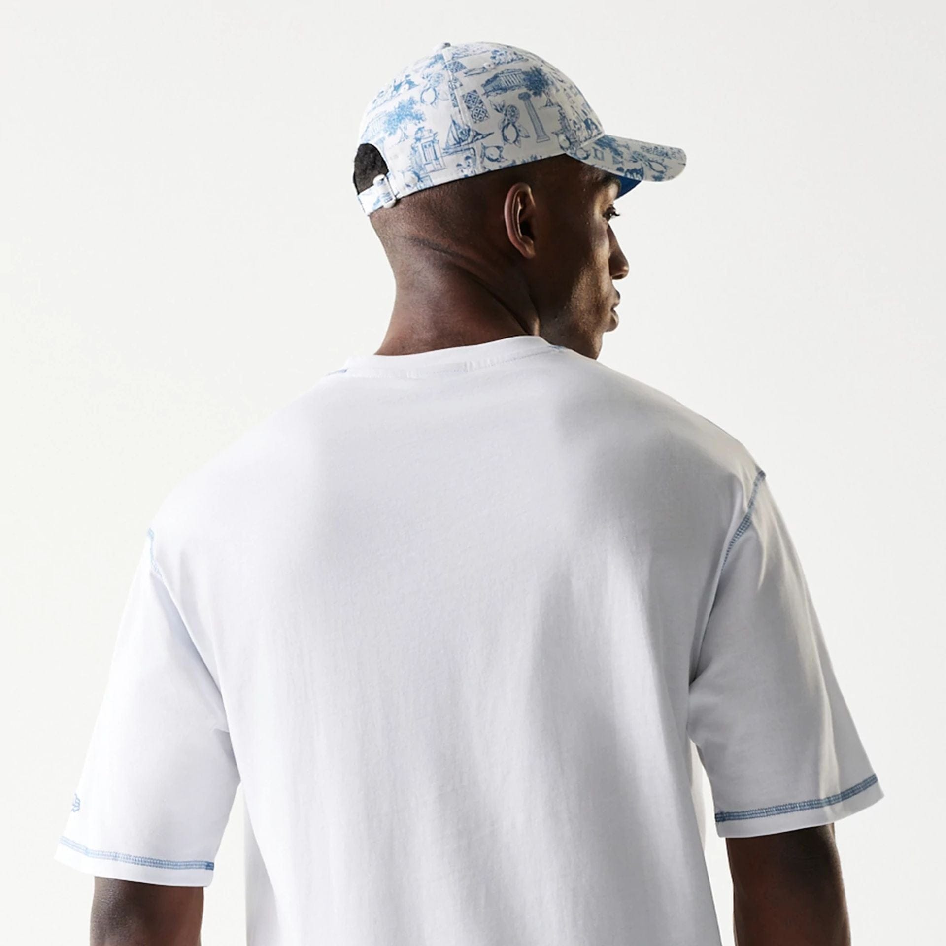 The Male model is wearing New Era Orthodox Vase White Oversized T-Shirt 7