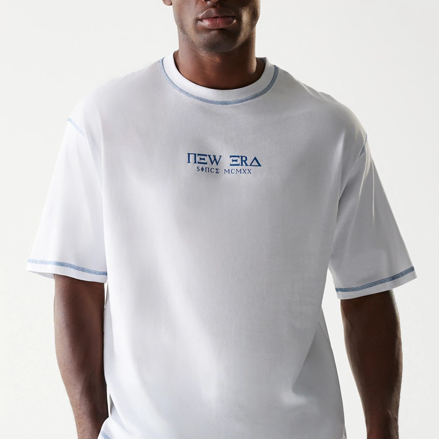 The Male model is wearing New Era Orthodox Church White Oversized T-Shirt 4