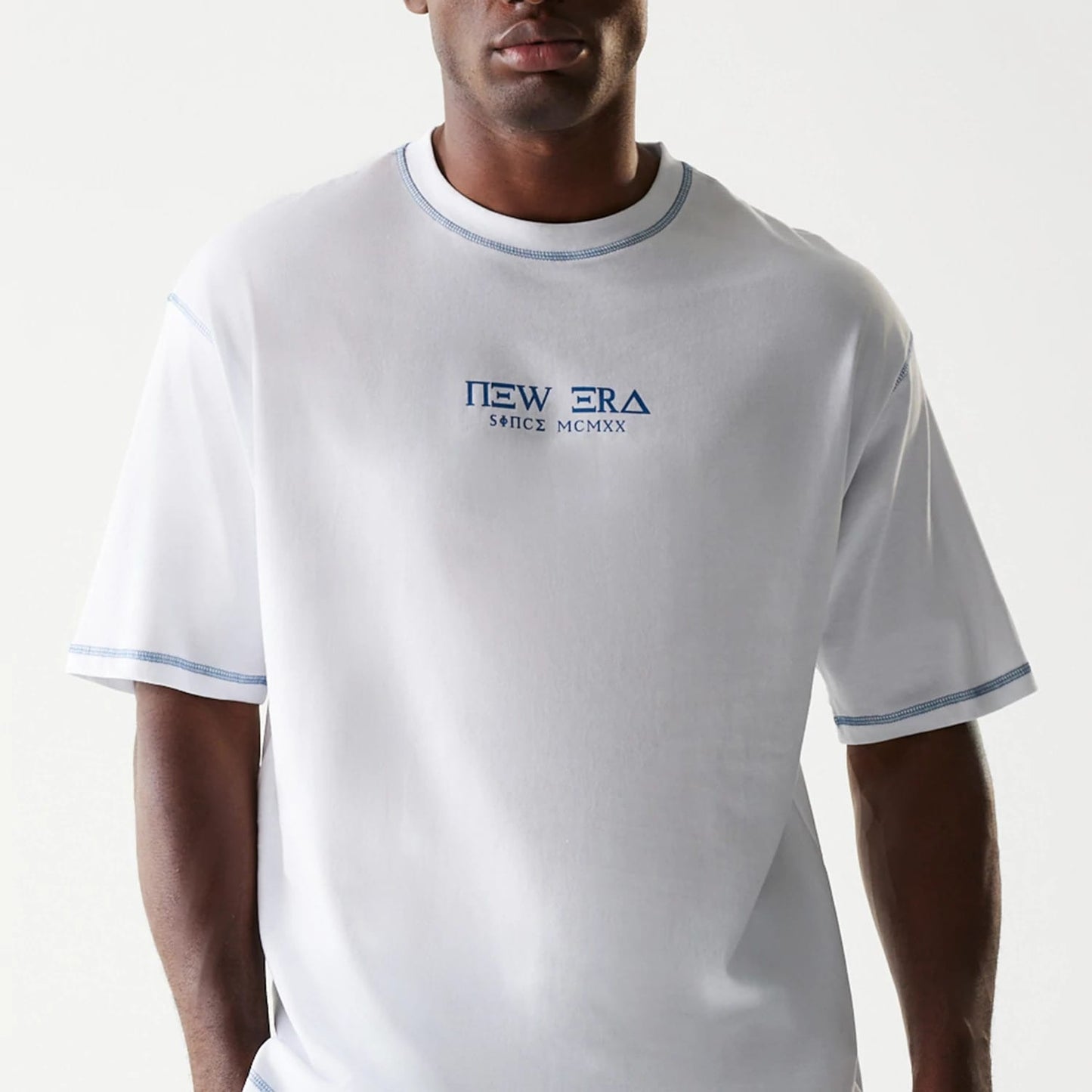 The Male model is wearing New Era Orthodox Church White Oversized T-Shirt 4