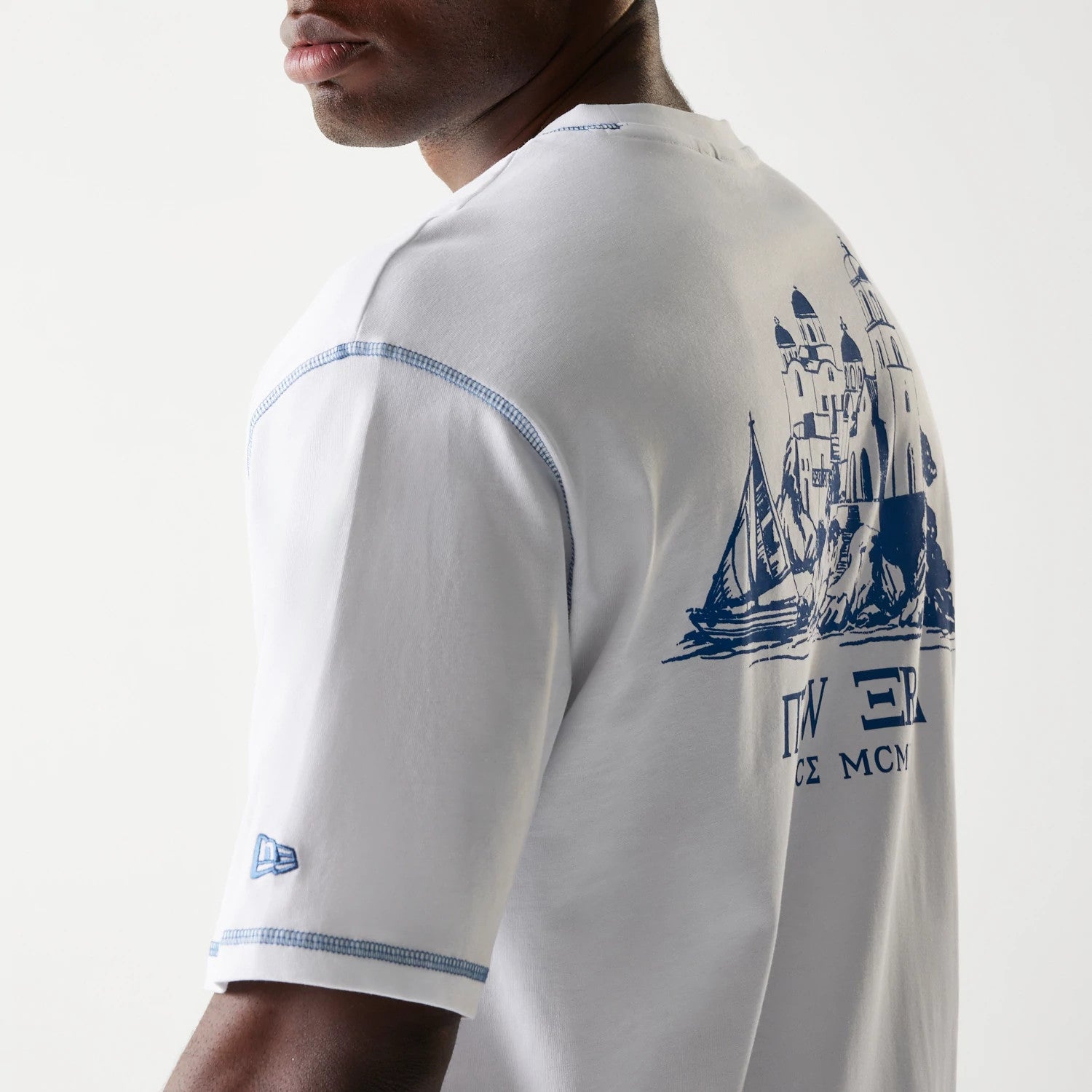 The Male model is wearing New Era Orthodox Church White Oversized T-Shirt 7