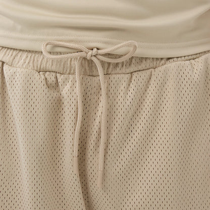 The Male model is wearing New Era Mesh Light Beige Mesh Shorts 5