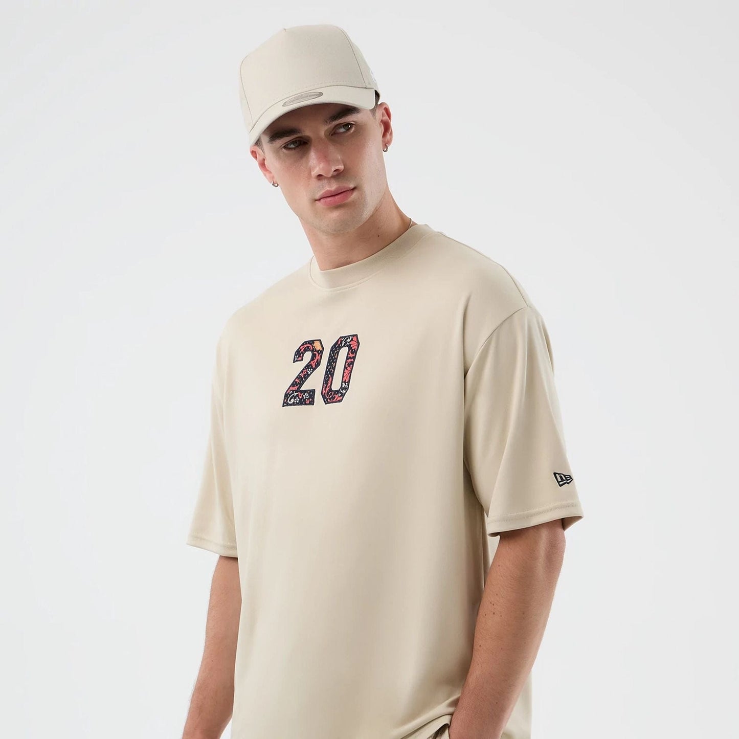 The Male model is wearing New Era Mesh Infill Light Beige Oversized T-Shirt 4