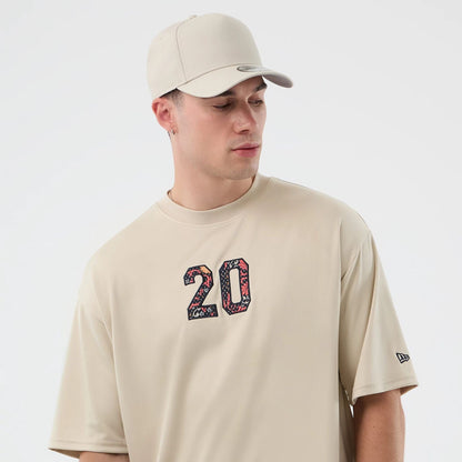 The Male model is wearing New Era Mesh Infill Light Beige Oversized T-Shirt 6